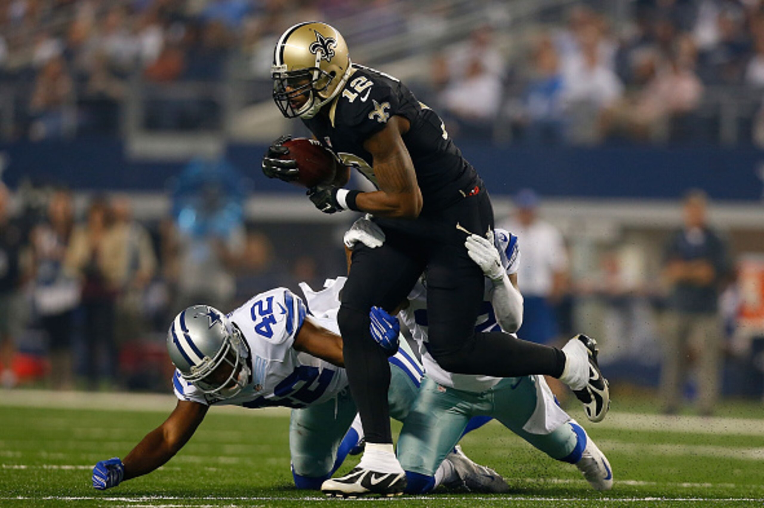 ARLINGTON, TX - SEPTEMBER 28:  Marques Colston #12 of the New Orleans Saints carries the ball as Barry Church #42 of the Dallas Cowboys and Orlando Scandrick #32 of the Dallas Cowboys try to make the tackle in the first half at AT&T Stadium on September 2