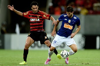 RECIFE, BRAZIL - SEPTEMBER 27: Ibson (L) of Sport Recife struggles for the ball with a Lucas Silva of Cruzeiro during a match between Sport Recife and Cruzeiro as part of Brasileirao Series A 2014 at Arena Pernanbuco on September 27, 2014 in Recife, Brazi
