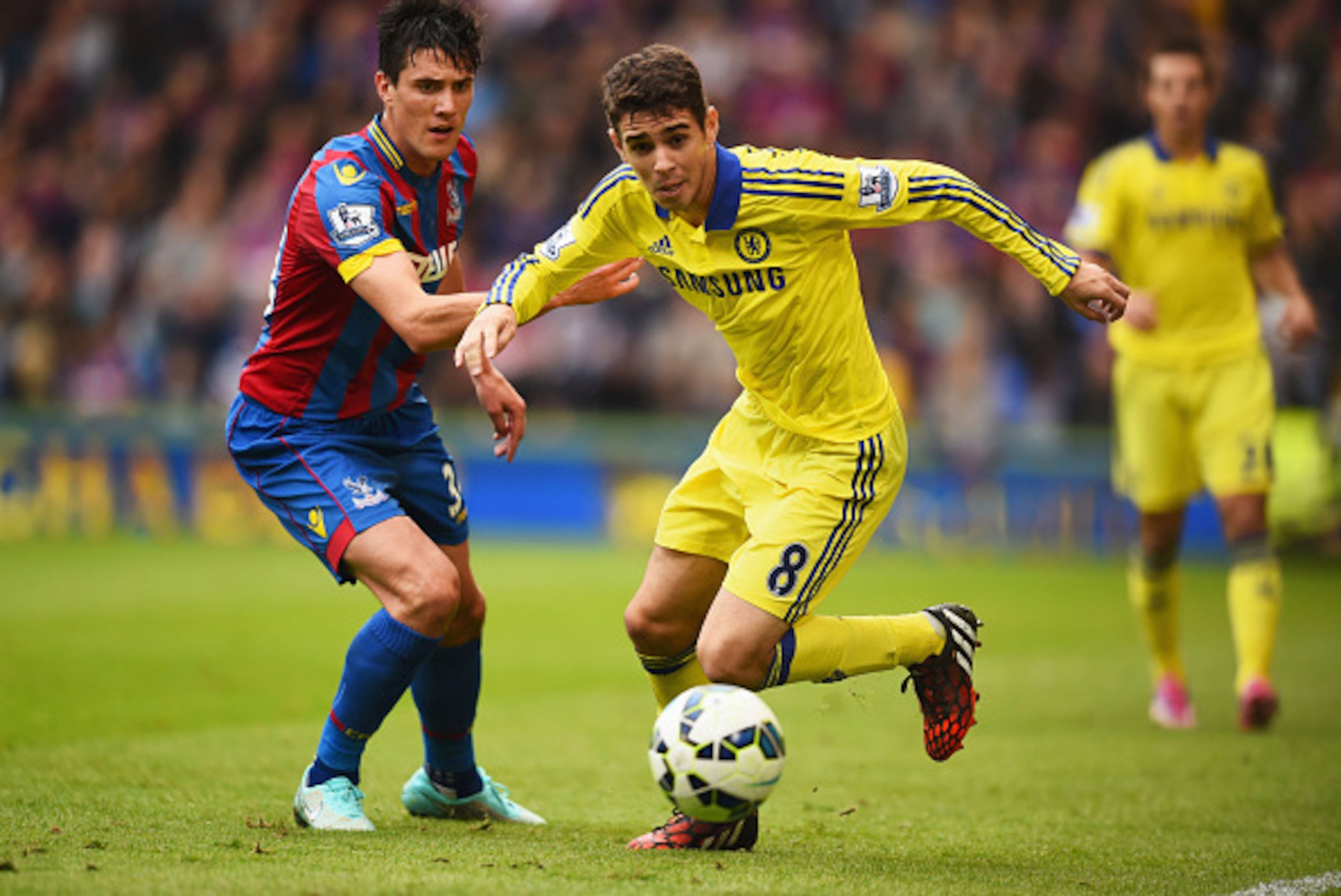 LONDON, ENGLAND - OCTOBER 18:  Oscar of Chelsea evades Martin Kelly of Crystal Palace during the Barclays Premier League match between Crystal Palace and Chelsea at Selhurst Park on October 18, 2014 in London, England.  (Photo by Paul Gilham/Getty Images)