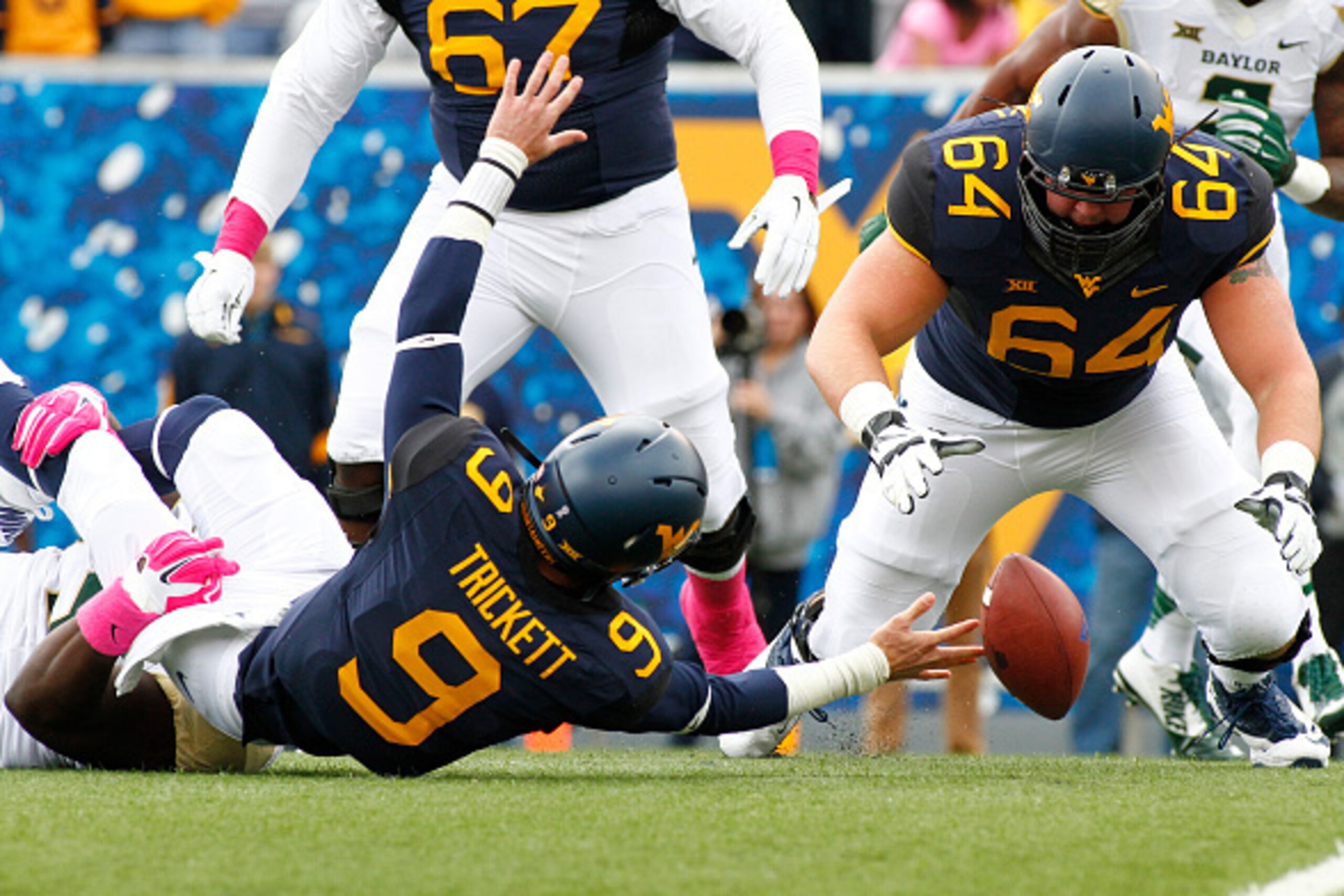 MORGANTOWN, WV - OCTOBER 18:  Andrew Billings #75 of the Baylor Bears sacks Clint Trickett #9 of the West Virginia Mountaineers causing a fumble as Mark Glowinski #64 looks for the ball in the first quarter during the game on October 18, 2014 at Mountaine