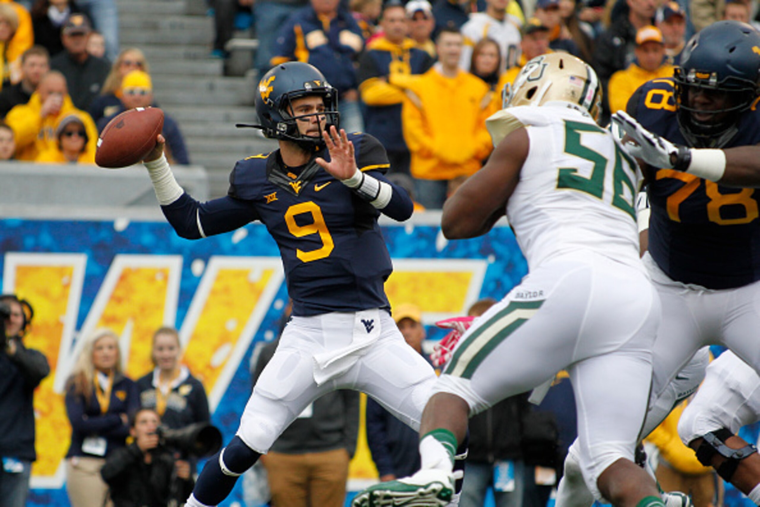 MORGANTOWN, WV - OCTOBER 18:  Clint Trickett #9 of the West Virginia Mountaineers drops back to pass against the Baylor Bears during the game on October 18, 2014 at Mountaineer Field in Morgantown, West Virginia.  West Virginia defeated Baylor 41-27.  (Ph