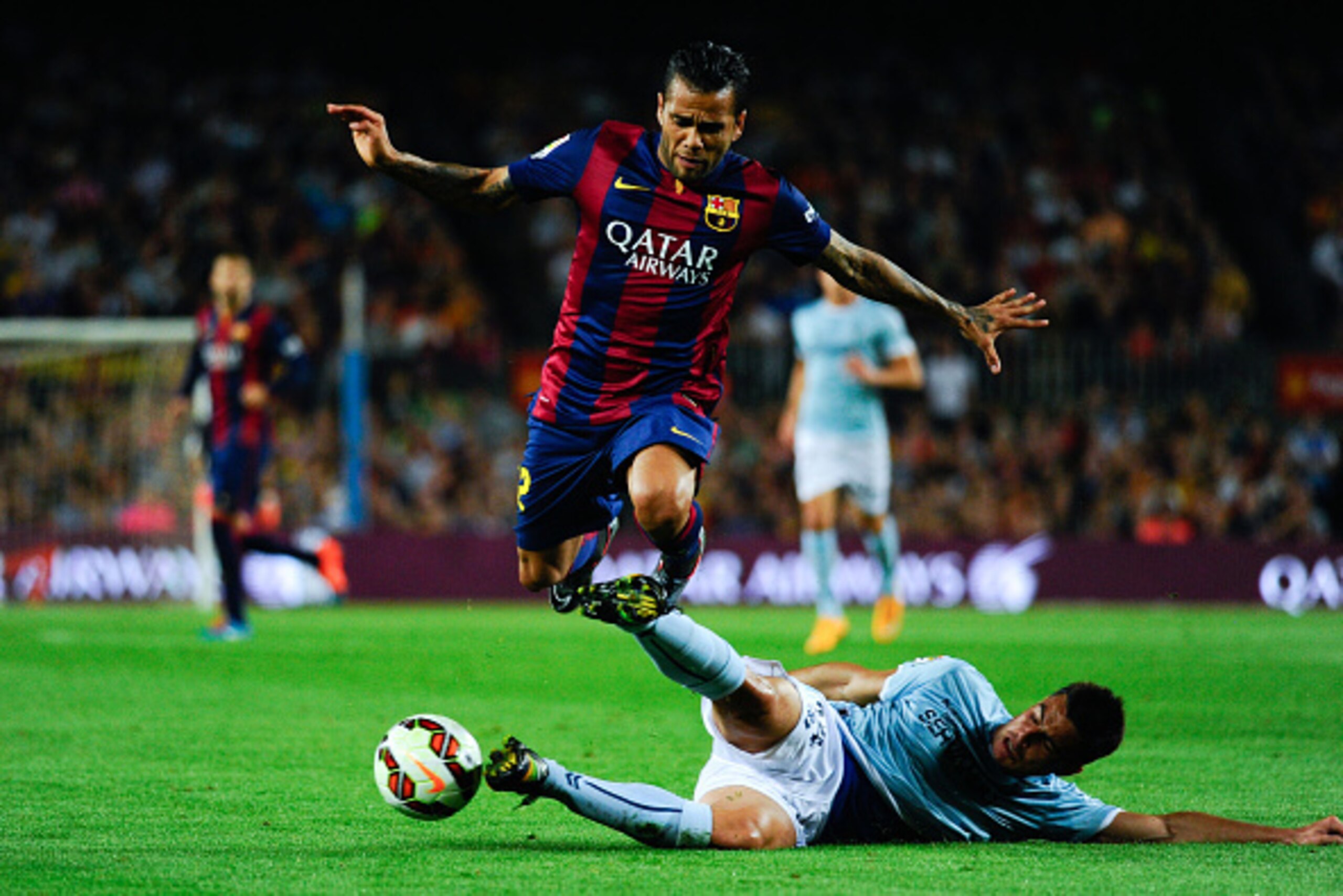 BARCELONA, SPAIN - OCTOBER 18: Dani Alves of FC Barcelona duels for the ball with Dani Garcia of SD Eibar during the La Liga match between FC Barcelona and SD Eibar at Camp Nou on October 18, 2014 in Barcelona, Spain.  (Photo by Sandra Montanez/Getty Imag