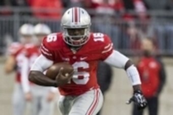 Oct 18, 2014; Columbus, OH, USA; Ohio State Buckeyes quarterback J.T. Barrett (16) carries the ball against the Rutgers Scarlet Knights at Ohio Stadium. The Buckeyes won 56-17.  Mandatory Credit: Greg Bartram-USA TODAY Sports