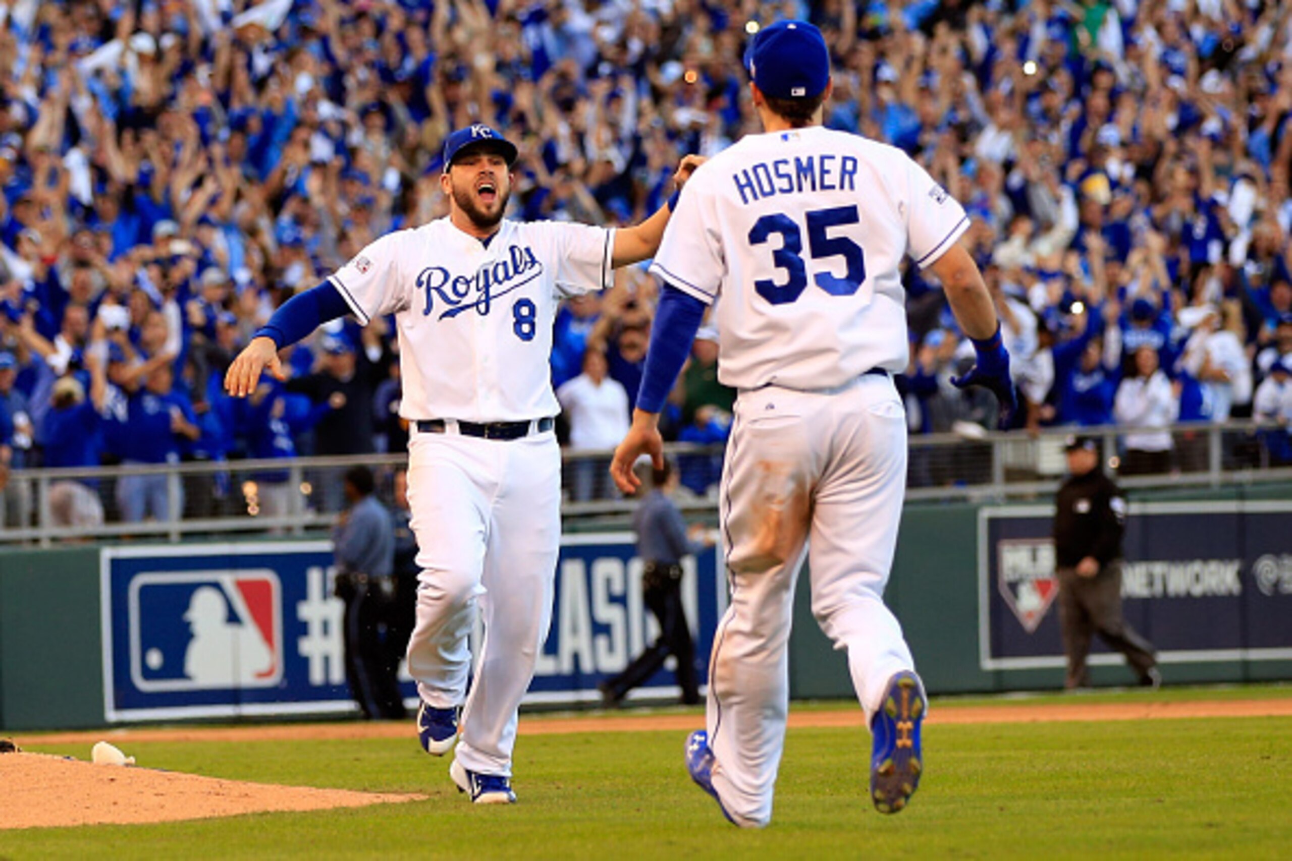 KANSAS CITY, MO - OCTOBER 15: Eric Hosmer #35 and Mike Moustakas #8 of the Kansas City Royals celebrate their 2 to 1 win over the Baltimore Orioles to sweep the series in Game Four of the American League Championship Series at Kauffman Stadium on October KANSAS CITY, MO - OCTOBER 15: Eric Hosmer #35 and Mike Moustakas #8 of the Kansas City Royals celebrate their 2 to 1 win over the Baltimore Orioles to sweep the series in Game Four of the American League Championship Series at Kauffman Stadium on October