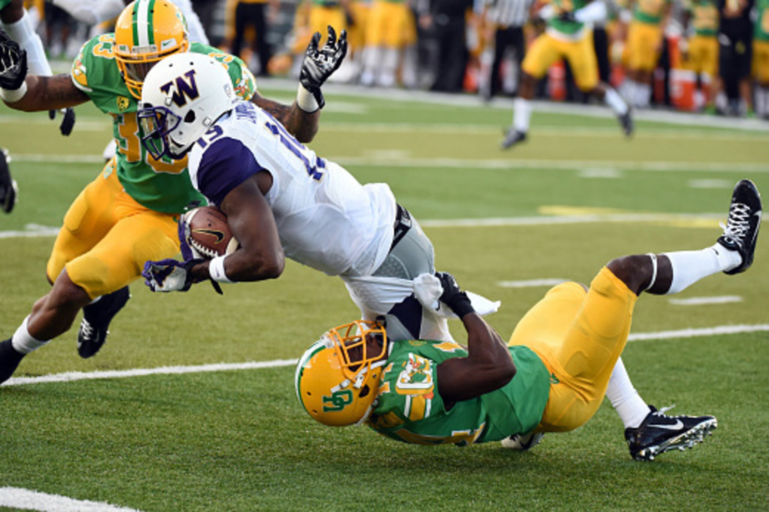 EUGENE,OR - OCTOBER 18: Defensive back Ifo Ekpre-Olomu #14 of the Oregon Ducks tackles wide receiver DiAndre Campbell #19 of the Washington Huskies during the second quarter of the game at Autzen Stadium on October 18, 2014 in Eugene, Oregon. (Photo by St