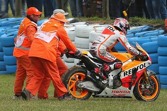 PHILLIP ISLAND, AUSTRALIA - OCTOBER 19: Marc Marquez of Spain who rides the #93 Repsol Honda Team Honda is helped back on his bike after crashing during the 2014 MotoGP of Australia at Phillip Island Grand Prix Circuit on October 19, 2014 in Phillip Islan