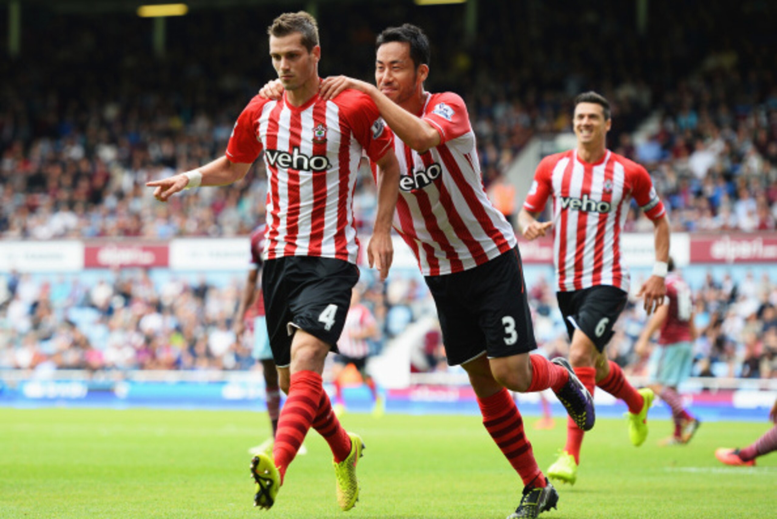 LONDON, ENGLAND - AUGUST 30: Morgan Schneiderlin of Southampton celebrates scoring his opening goal with Maya Yoshida of Southampton during the Barclays Premier League match between West Ham United and Southampton at Boleyn Ground on August 30, 2014 in Lo