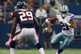 ARLINGTON, TX - OCTOBER 05:  Joseph Randle #21 of the Dallas Cowboys carries the ball as Andre Hal #29 of the Houston Texans tries to position for the tackle in the first half at AT&T Stadium on October 5, 2014 in Arlington, Texas.  (Photo by Tom Penningt