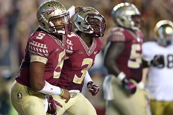 TALLAHASSEE, FL - OCTOBER 18:  Teammates Jameis Winston #5 and Jesus Wilson #3 of the Florida State Seminoles react after a touchdown against the Notre Dame Fighting Irish during their game at Doak Campbell Stadium on October 18, 2014 in Tallahassee, Flor