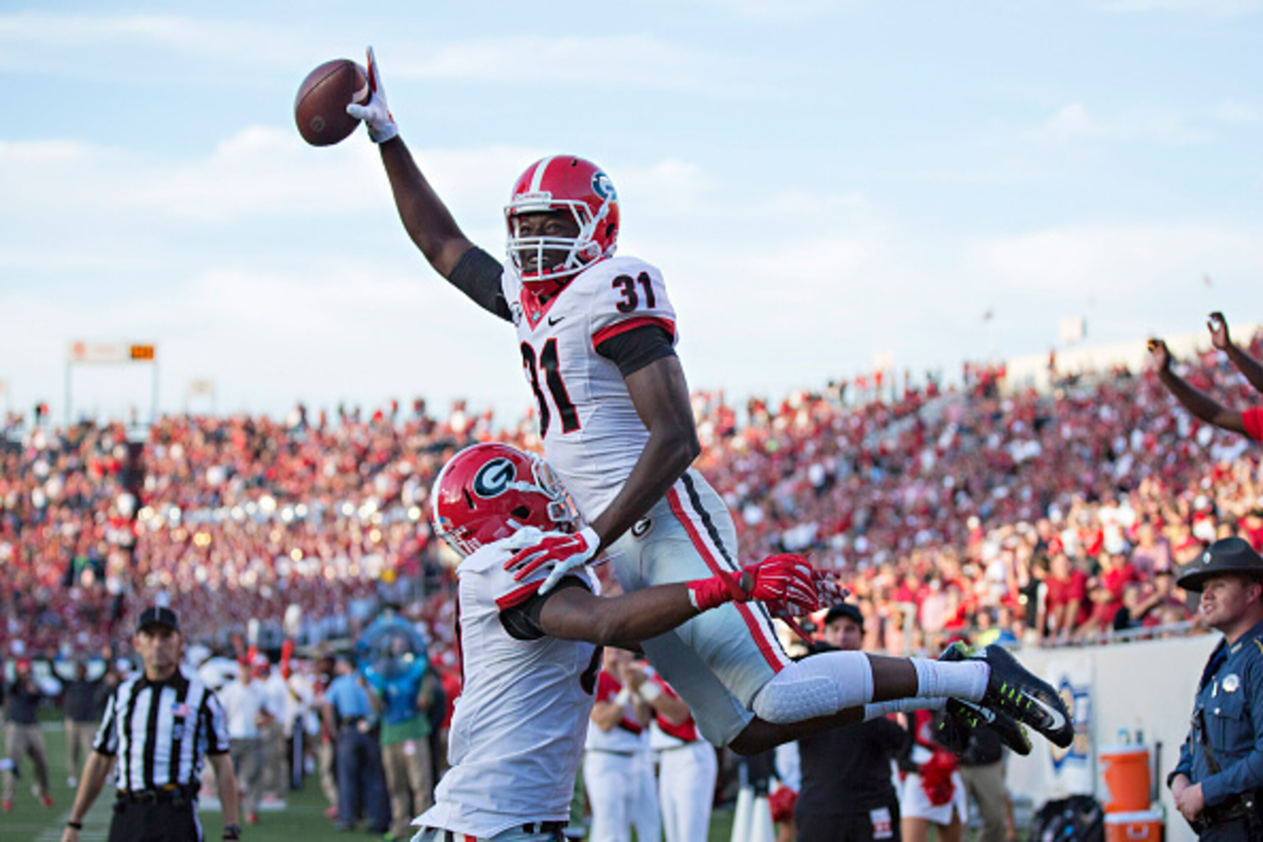 LITTLE ROCK, AR - OCTOBER 18:  Chris Conley #31 of the Georgia Bulldogs is lifted in the air after scoring a touchdown against the Arkansas Razorbacks at War Memorial Stadium on October 18, 2014 in Little Rock, Arkansas.  The Bulldogs defeated the Razorba