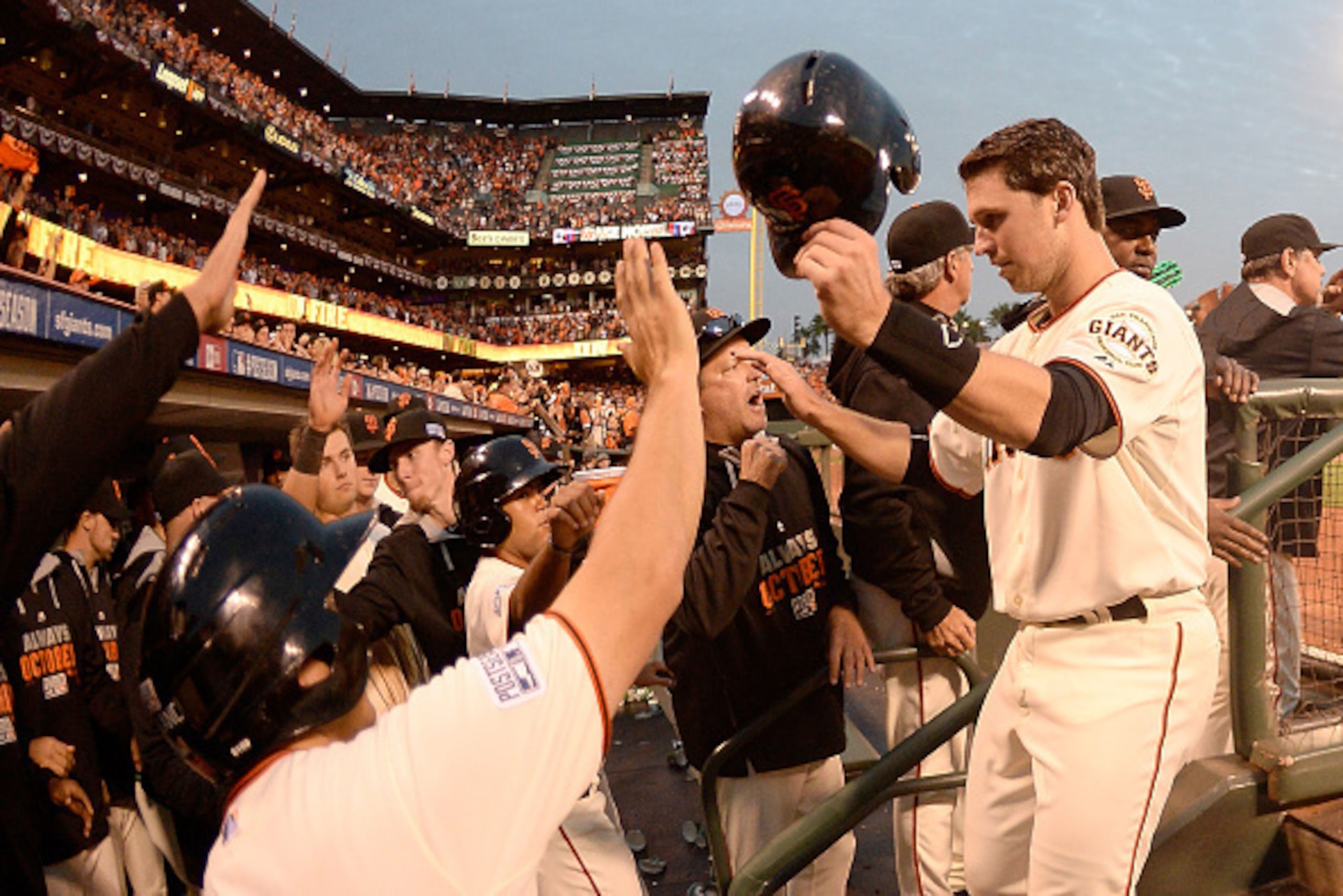 SAN FRANCISCO, CA - OCTOBER 15: Buster Posey #28 of the San Francisco Giants celebrates with teammates after scoring in the third inning against the St. Louis Cardinals during Game Four of the National League Championship Series at AT&T Park on October 1 SAN FRANCISCO, CA - OCTOBER 15: Buster Posey #28 of the San Francisco Giants celebrates with teammates after scoring in the third inning against the St. Louis Cardinals during Game Four of the National League Championship Series at AT&T Park on October 1