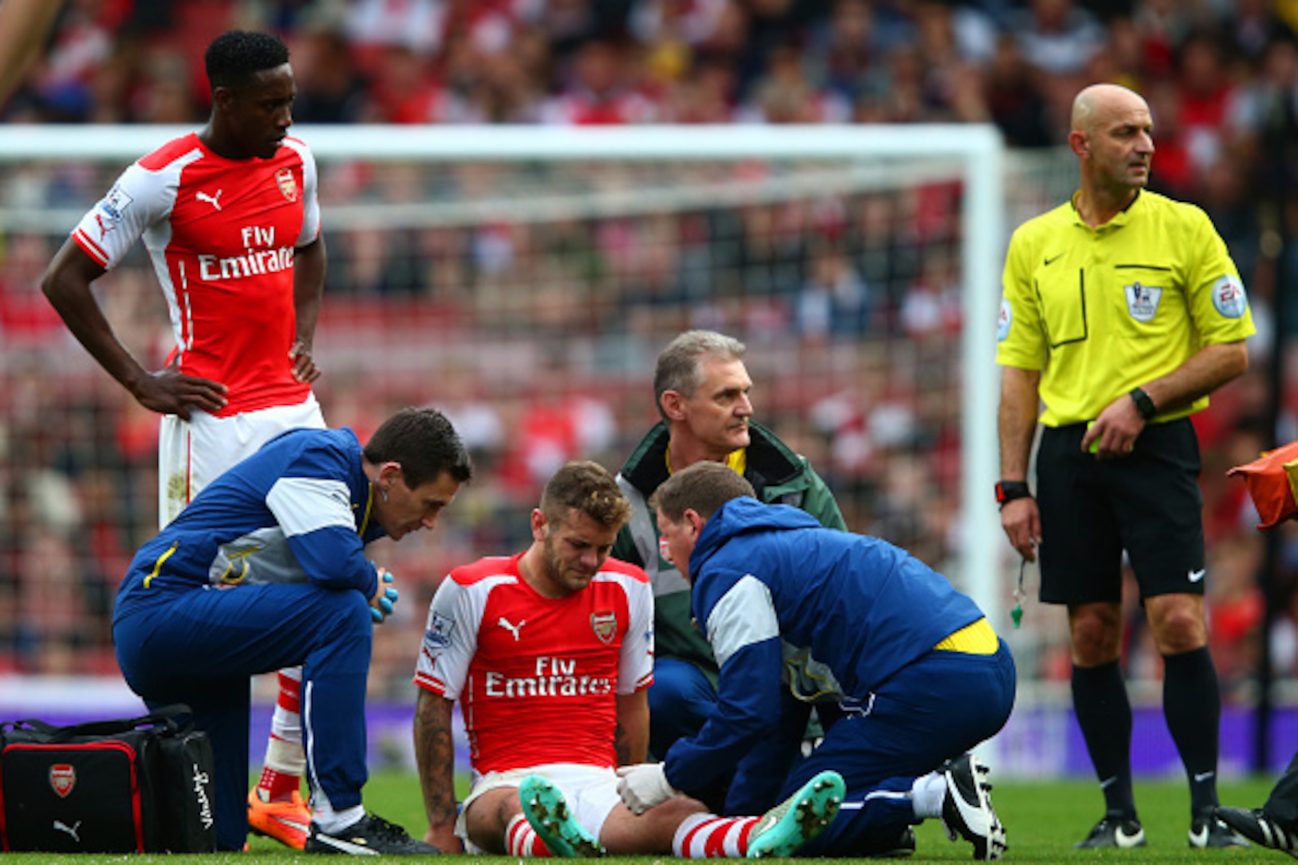 LONDON, ENGLAND - OCTOBER 18:  Jack Wilshere of Arsenal receives treatment before being substituted with an injury during the Barclays Premier League match between Arsenal and Hull City at Emirates Stadium on October 18, 2014 in London, England.  (Photo b