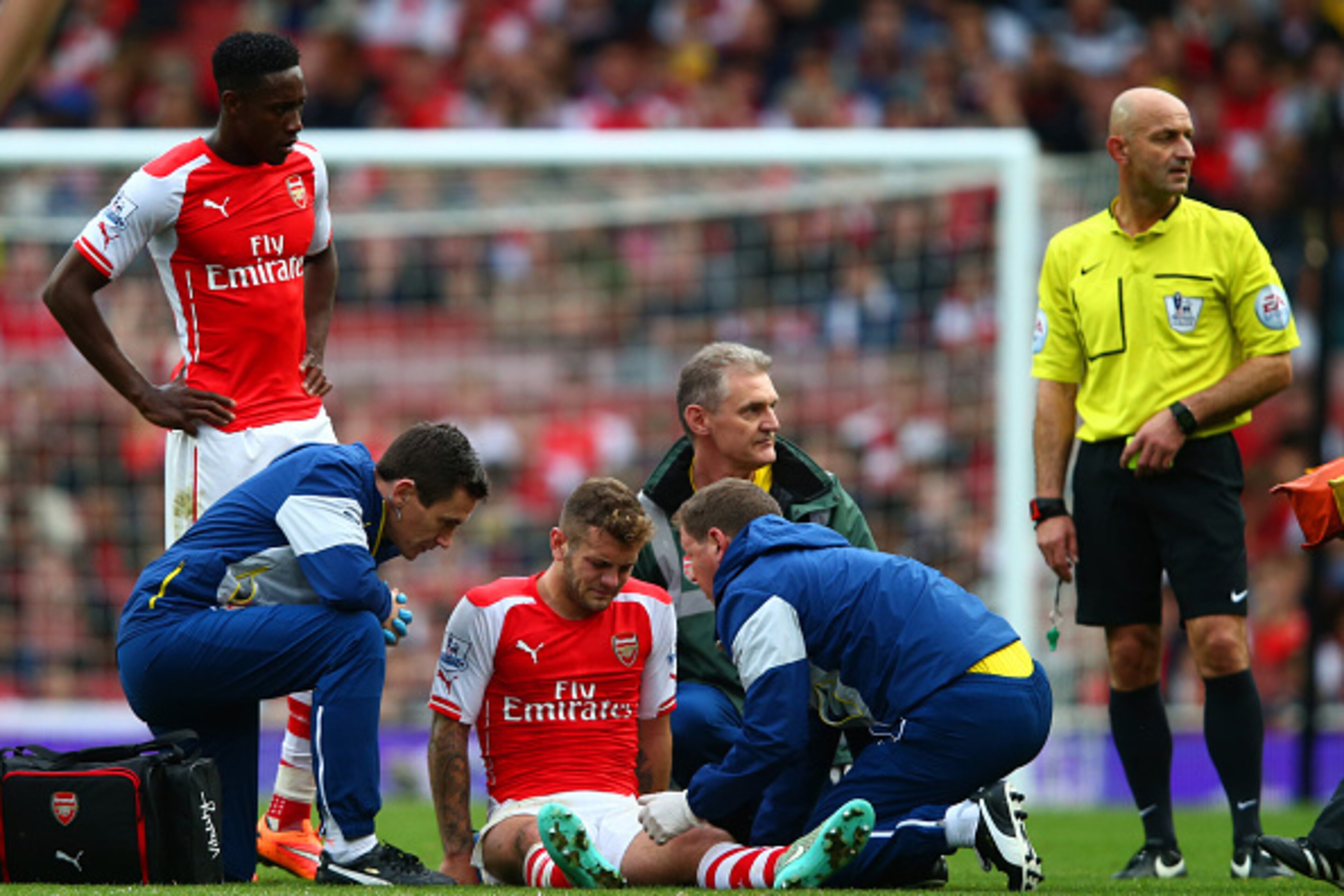 LONDON, ENGLAND - OCTOBER 18:  Jack Wilshere of Arsenal receives treatment before being substituted with an injury during the Barclays Premier League match between Arsenal and Hull City at Emirates Stadium on October 18, 2014 in London, England.  (Photo b