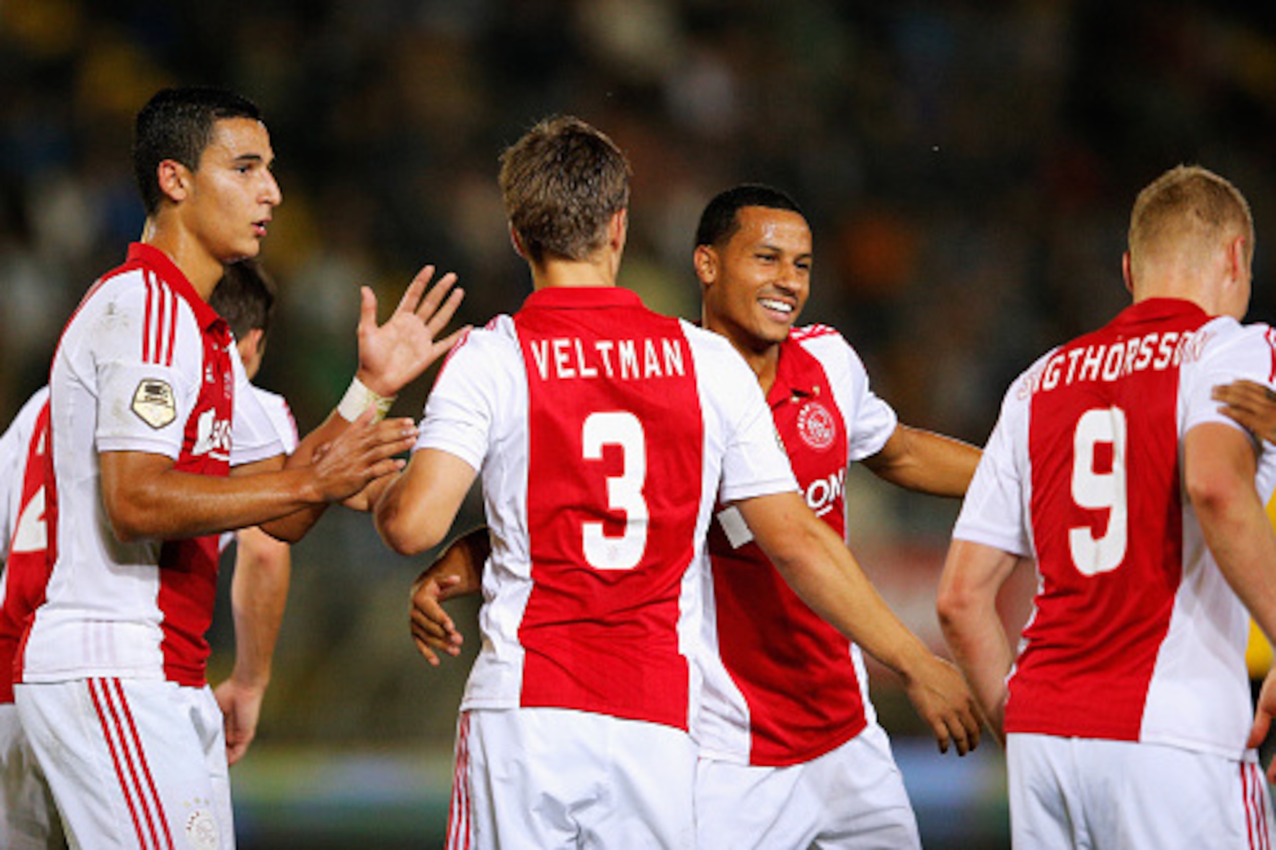 BREDA, NETHERLANDS - SEPTEMBER 27:  Joel Veltman (#3) of Ajax is congratulated after he shoots and scores a goal with team mates during the Dutch Eredivisie match between NAC Breda and Ajax Amsterdam at the Rat Verlegh Stadion on September 27, 2014 in Bre