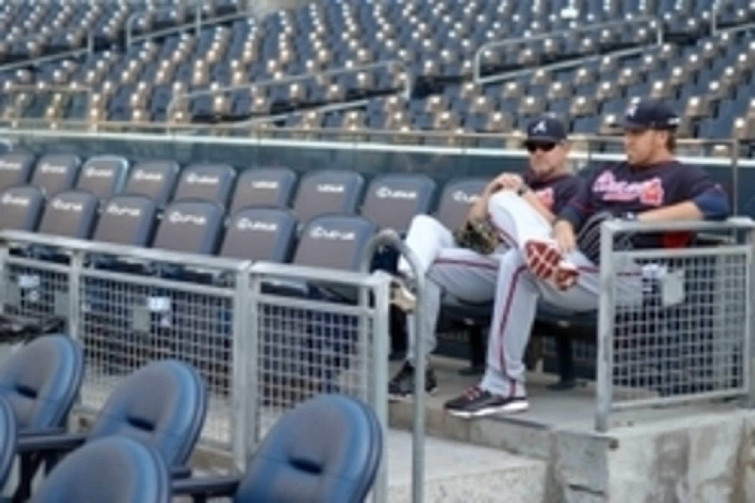 Aug 1, 2014; San Diego, CA, USA; Atlanta Braves starting pitcher Aaron Harang (right) and Atlanta Braves pitching coach Roger McDowell sit in the stands before a game against the San Diego Padres at Petco Park. Mandatory Credit: Jake Roth-USA TODAY Sports