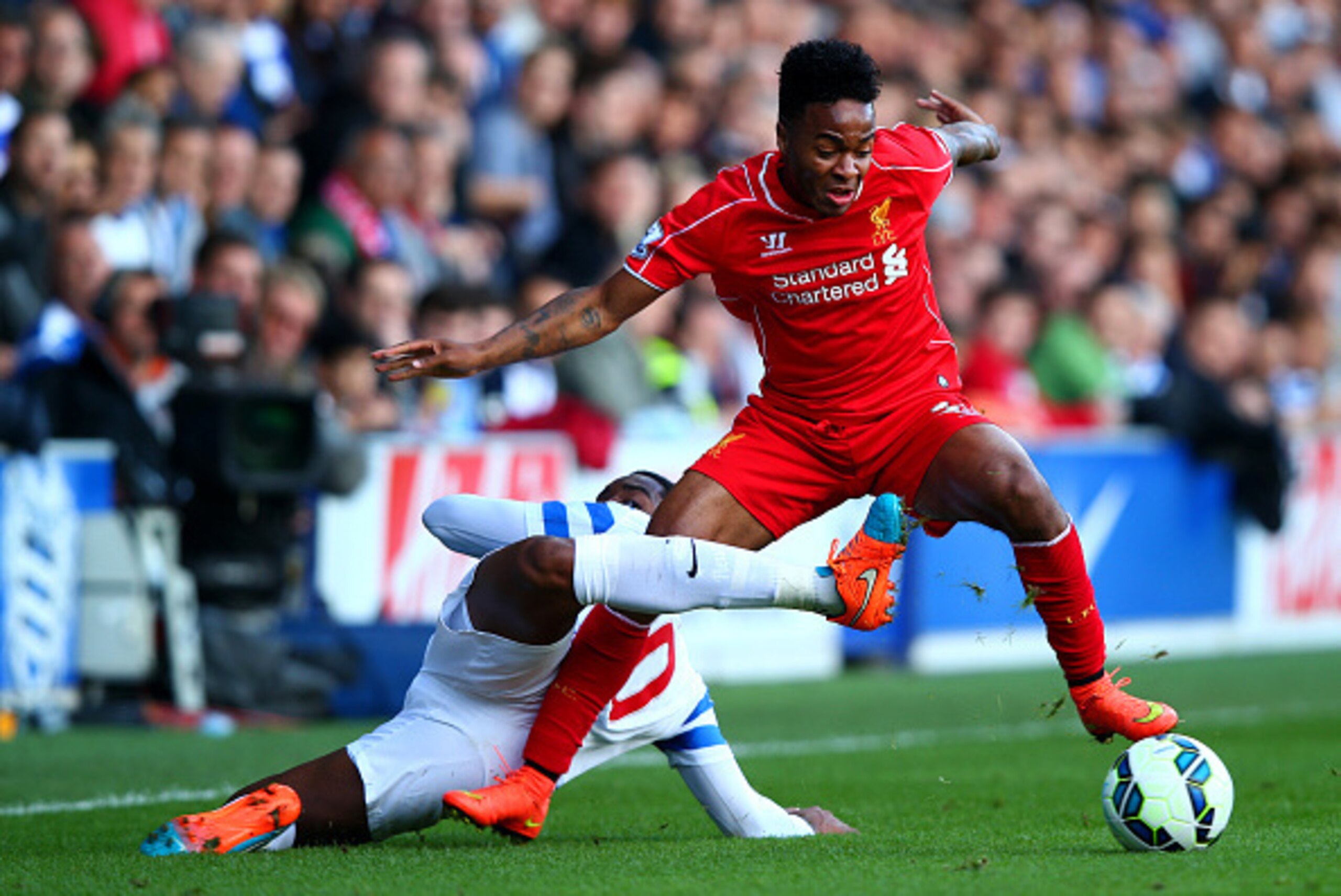 LONDON, ENGLAND - OCTOBER 19:  Raheem Sterling of Liverpool battles for the ball with Leroy Fer of QPR during the Barclays Premier League match between Queens Park Rangers and Liverpool at Loftus Road on October 19, 2014 in London, England.  (Photo by Cli