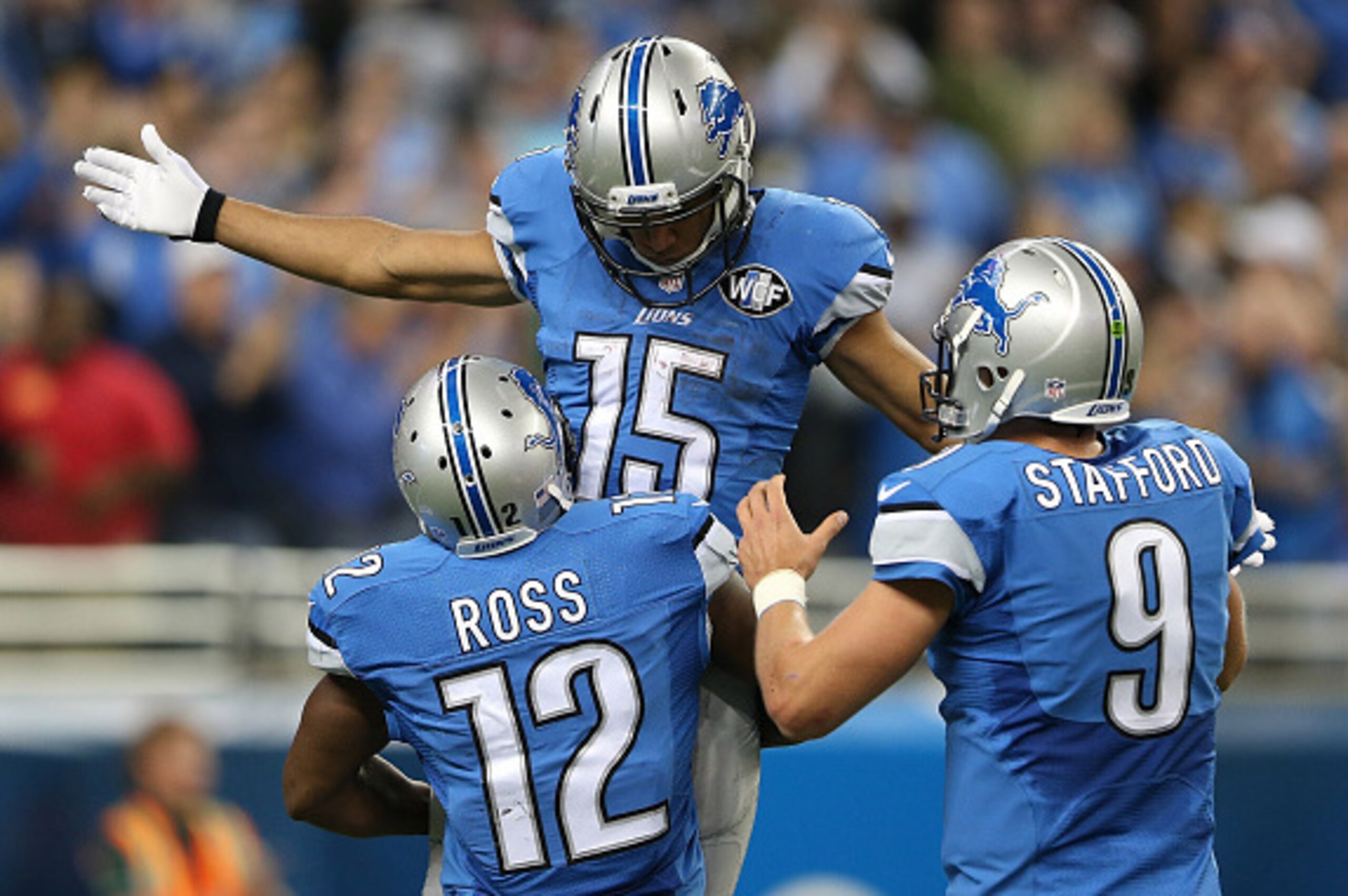 DETROIT, MI - OCTOBER 19: Golden Tate #15, Jeremy Ross #12 and Matthew Stafford #9 of the Detroit Lions celebrate a fourth quarter touchdown against the New Orleans Saints at Ford Field on October 19, 2014 in Detroit, Michigan. (Photo by Leon Halip/Getty 