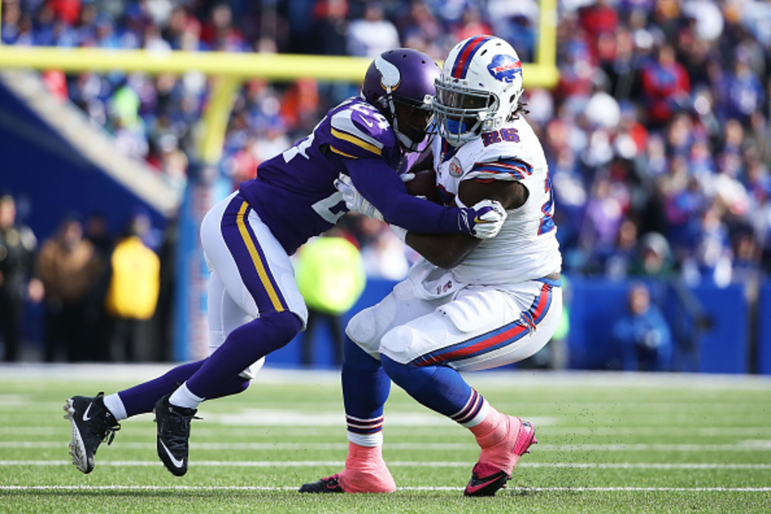 ORCHARD PARK, NY - OCTOBER 19:   Anthony Dixon #26 of the Buffalo Bills is tackled by Captain Munnerlyn #24 of the Minnesota Vikings during the second half at Ralph Wilson Stadium on October 19, 2014 in Orchard Park, New York.  (Photo by Tom Szczerbowski/