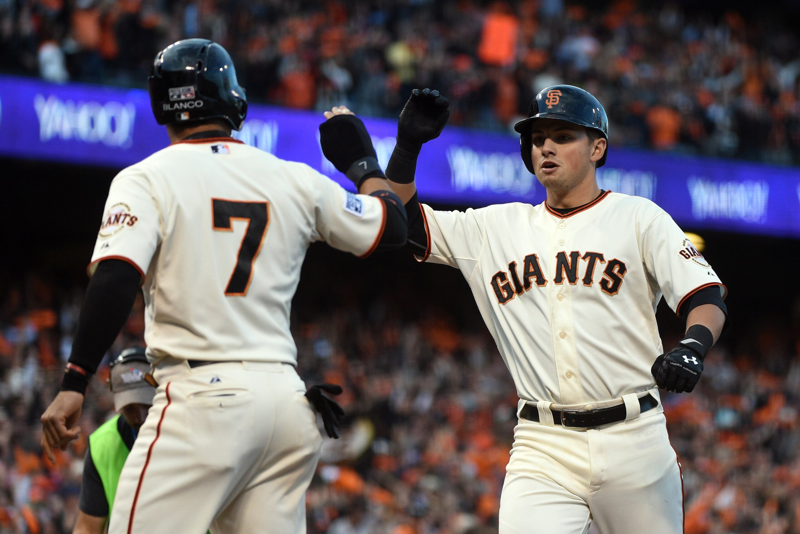Oct 16, 2014; San Francisco, CA, USA; San Francisco Giants second baseman Joe Panik (12) celebrates with center fielder Gregor Blanco (7) after hitting a two run home run against the St. Louis Cardinals during the third inning of game five of the 2014 NLC