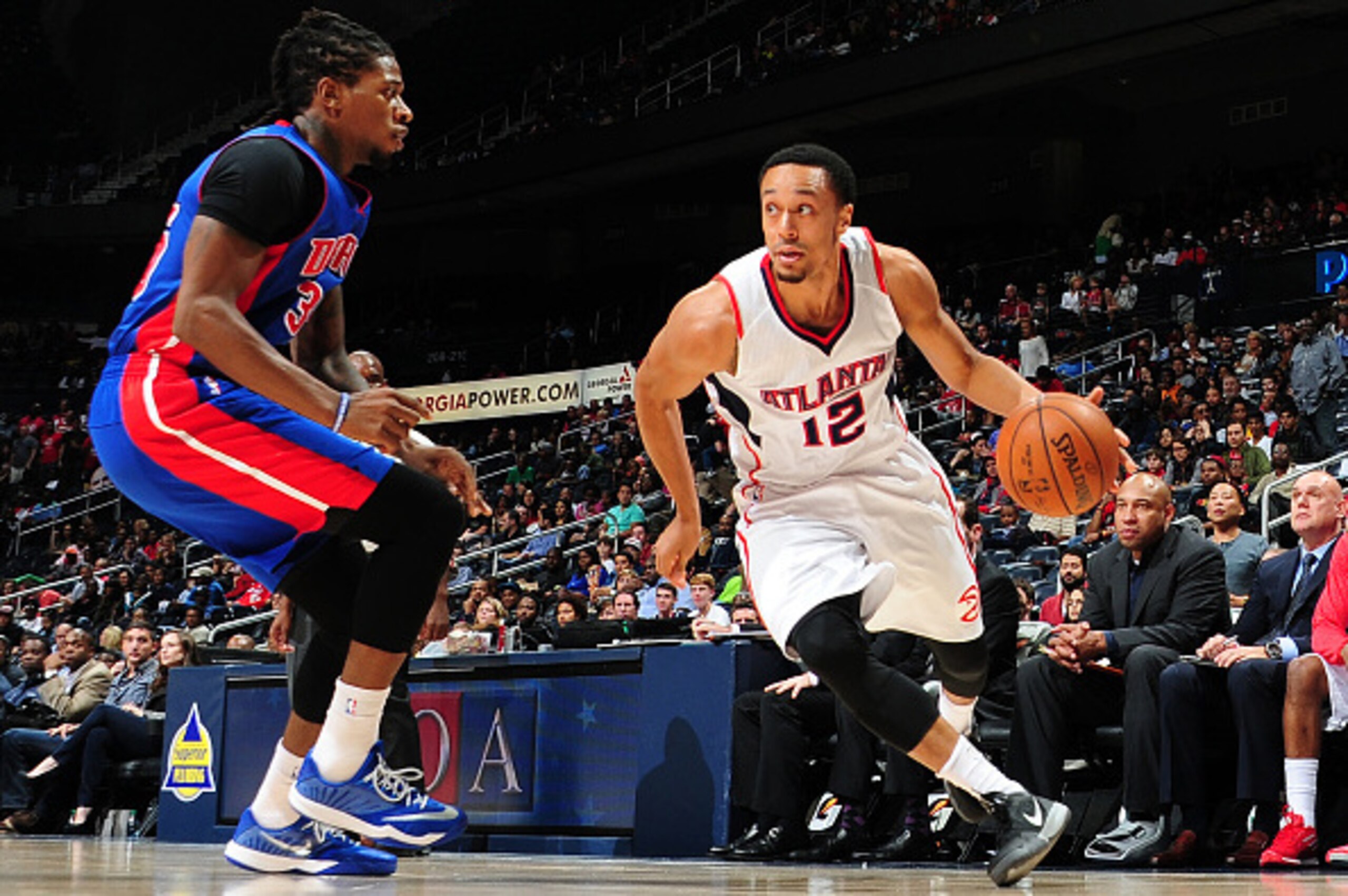 ATLANTA, GA - OCTOBER 18: John Jenkins #12 of the Atlanta Hawks drives against the Detroit Pistons on October 18, 2014 at Philips Arena in Atlanta, Georgia.  NOTE TO USER: User expressly acknowledges and agrees that, by downloading and/or using this Photo