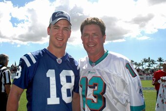 Indianapolis Colts quarterback Peyton Manning  and Miami Dolphins quarterback Dan Marino pose for a photo  during a flag-football legends  game during 2005 Pro Bowl week in Ko Olina, Honolulu February 11, 2005.  (Photo by Al Messerschmidt/Getty Images)