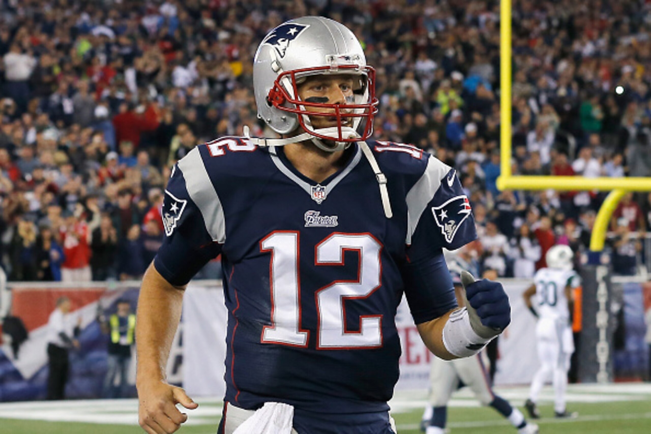 FOXBORO, MA - OCTOBER 16:  Tom Brady #12 of the New England Patriots reacts after throwing a touchdown pass during the fourth quarter against the New York Jets at Gillette Stadium on October 16, 2014 in Foxboro, Massachusetts.  (Photo by Jim Rogash/Getty 
