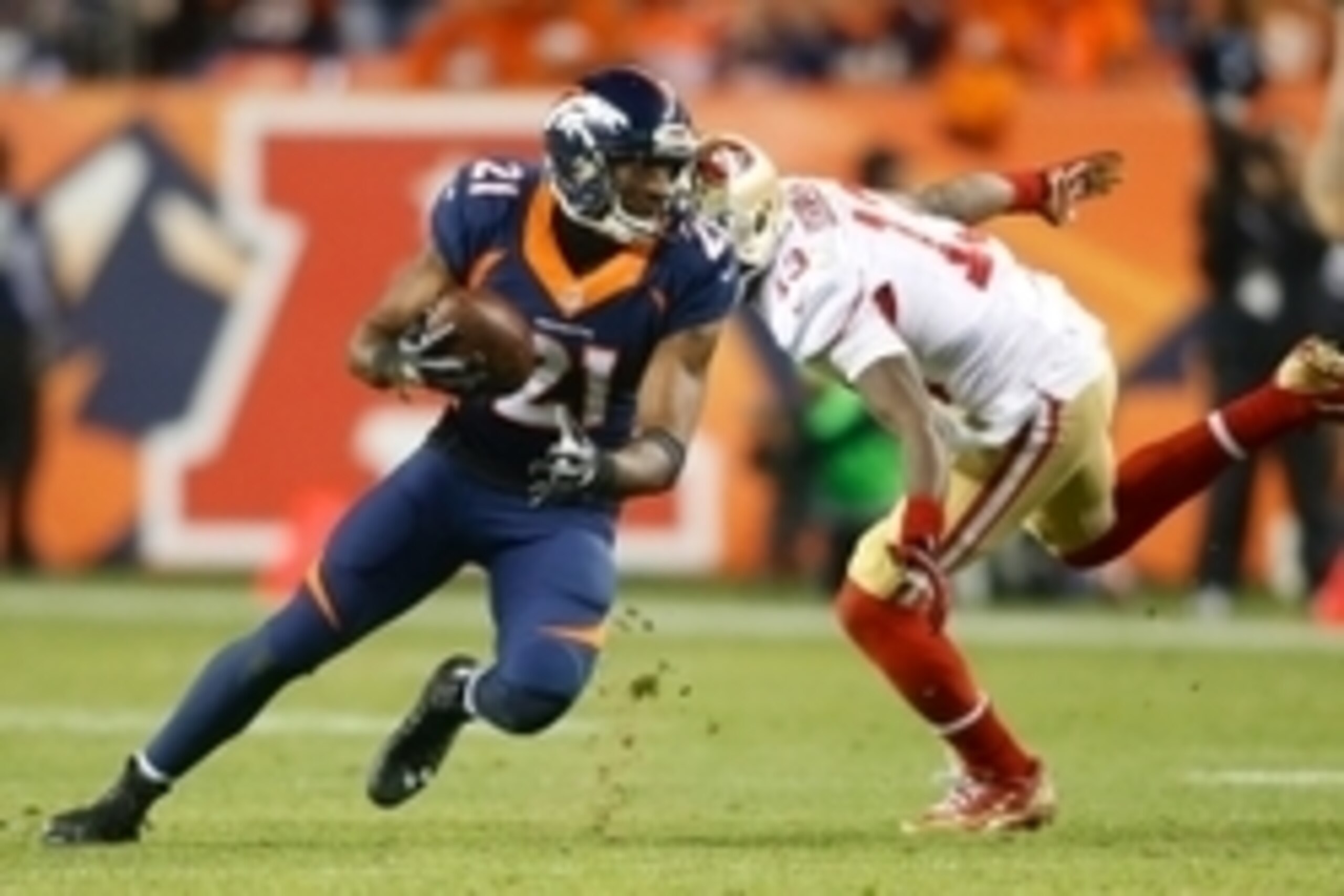 Oct 19, 2014; Denver, CO, USA; Denver Broncos cornerback Aqib Talib (21) intercepts a pass intended for San Francisco 49ers wide receiver Steve Johnson (13) in the third quarter at Sports Authority Field at Mile High. Mandatory Credit: Chris Humphreys-USA