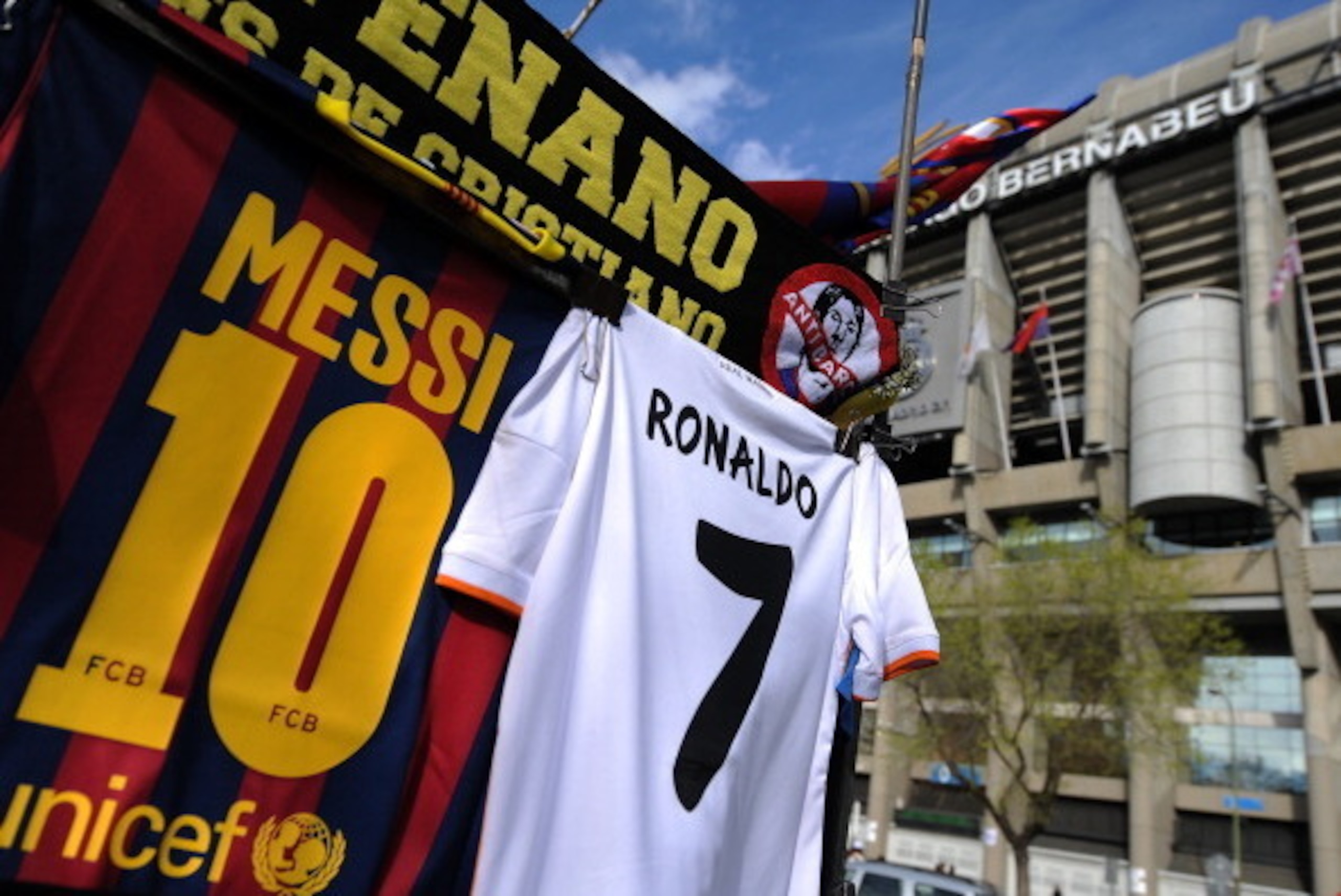 MADRID, SPAIN - MARCH 23: Shirts bearing the names of Lionel Messi of FC Barcelona and Cristiano Ronaldo of Real Madrid CF are see at a merchandise stall prior to the La Liga match between Real Madrid CF and FC Barcelona at estadio Santiago Bernabeu on M MADRID, SPAIN - MARCH 23: Shirts bearing the names of Lionel Messi of FC Barcelona and Cristiano Ronaldo of Real Madrid CF are see at a merchandise stall prior to the La Liga match between Real Madrid CF and FC Barcelona at estadio Santiago Bernabeu on M