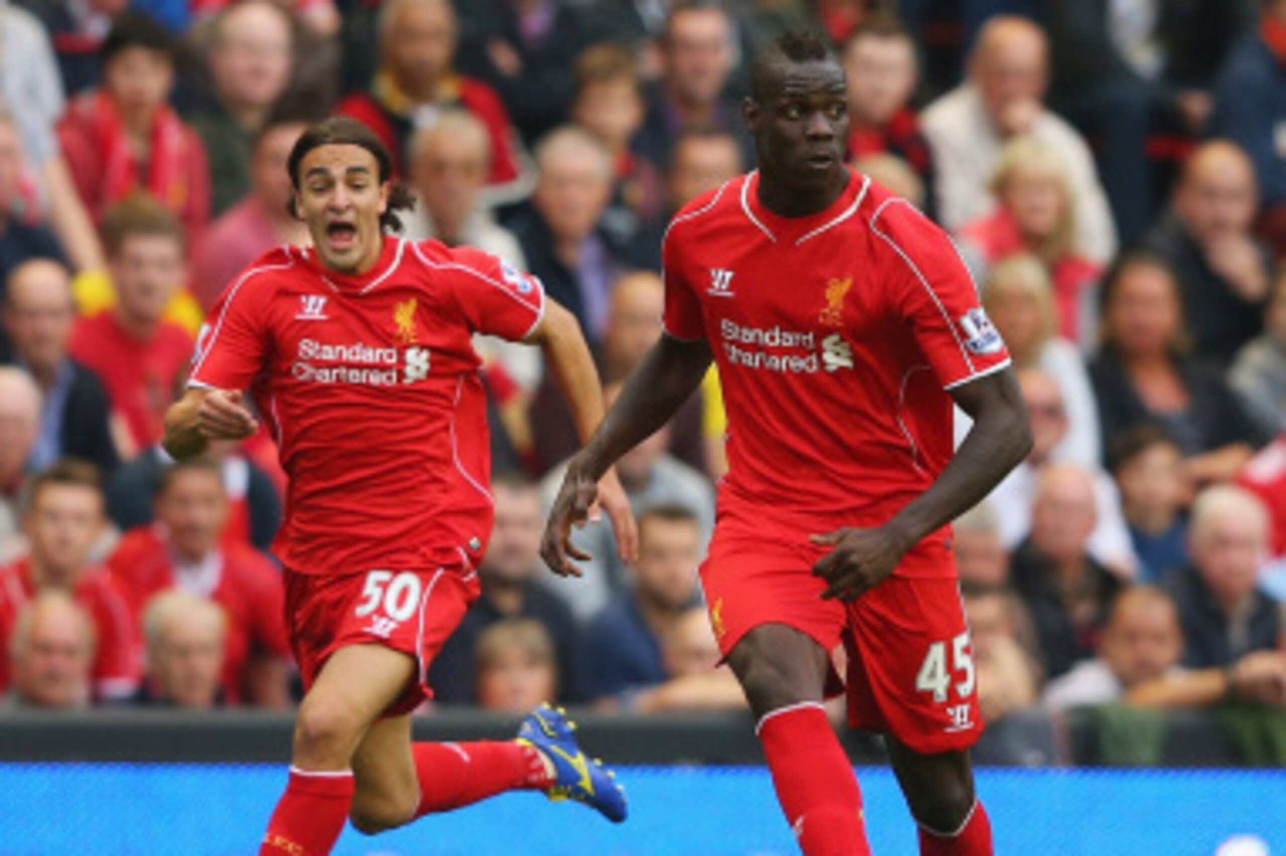 LIVERPOOL, ENGLAND - SEPTEMBER 13:  Mario Balotelli of Liverpool passes with Lazar Markovic of Liverpool on the overlap during the Barclays Premier League match between Liverpool and Aston Villa at Anfield on September 13, 2014 in Liverpool, England.  (Ph