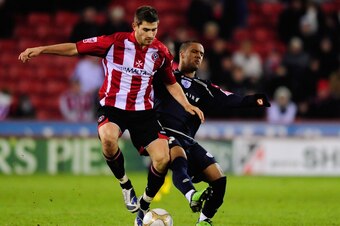 SHEFFIELD, ENGLAND - JANUARY 03:  Ched Evans of Sheffield United battles with Wayne Routledge of Queens Park Rangers during the FA Cup sponsored by E.ON 3rd Round match between Sheffield United and Queens Park Rangers at Bramall Lane on January 3, 2010 in