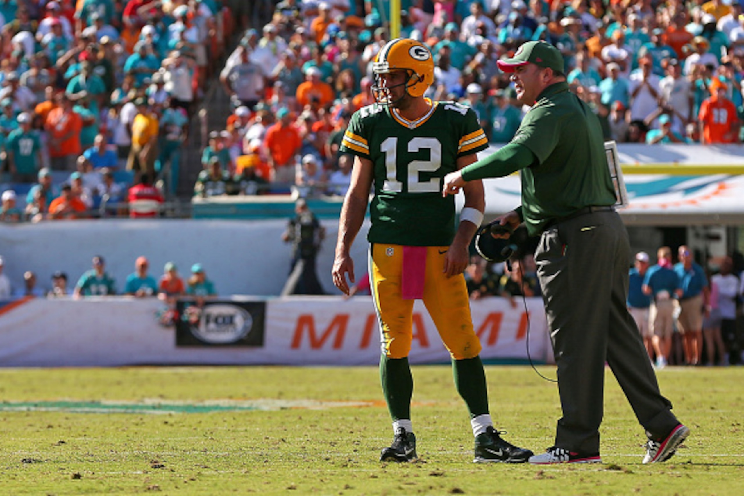MIAMI GARDENS, FL - OCTOBER 12: Aaron Rodgers #12 of the Green Bay Packers talks with head coach Mike McCarthy before the final play during a game against the Miami Dolphins at Sun Life Stadium on October 12, 2014 in Miami Gardens, Florida.  (Photo by Mik