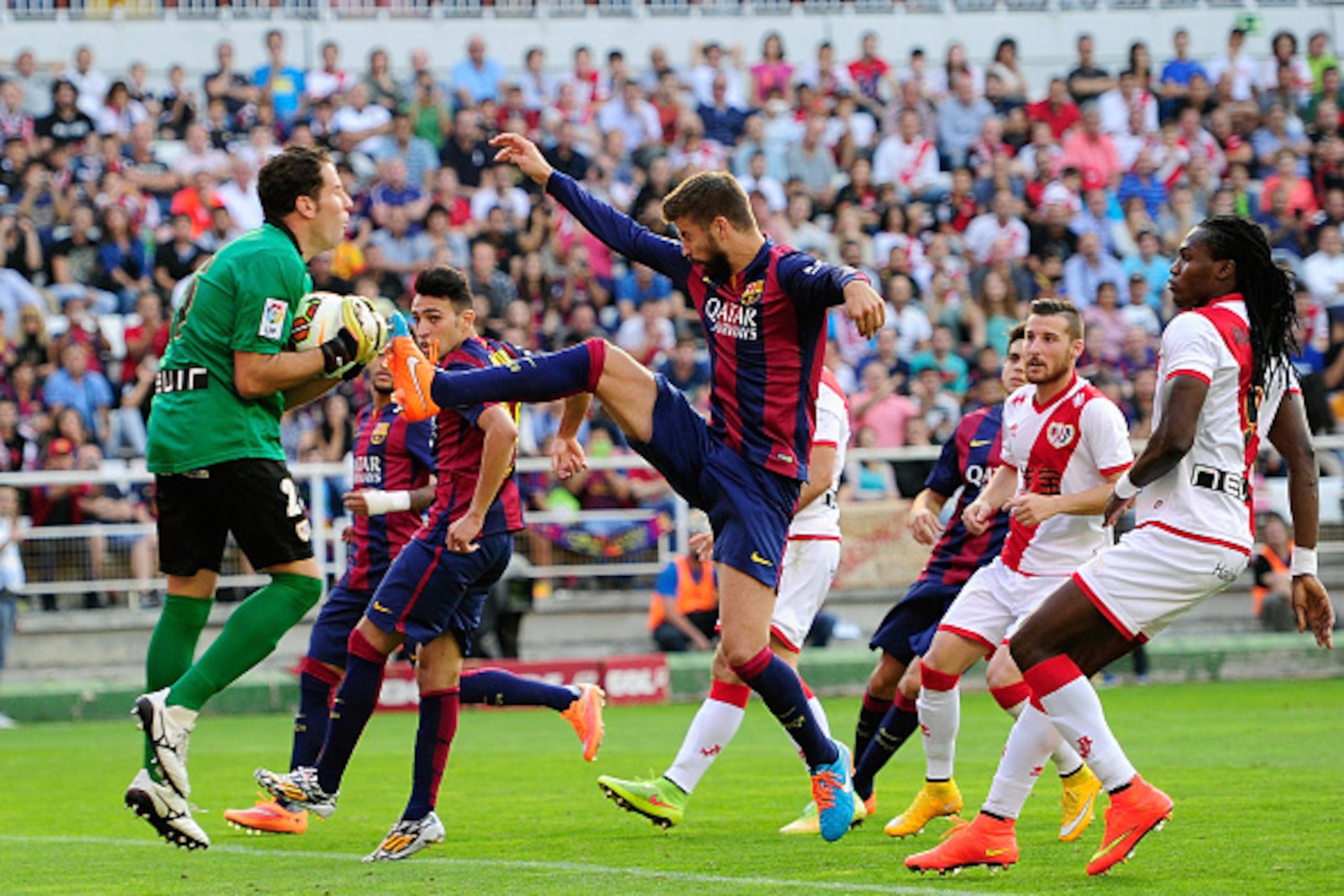 MADRID, SPAIN - OCTOBER 04:  Gerard Pique of FC Barcelona battles for the ball against Tono Rodriguez of Rayo Vallecano de Madrid to score his team's opening goal during the La Liga match between Rayo Vallecano de Madrid and FC Barcelona at Estadio Teresa