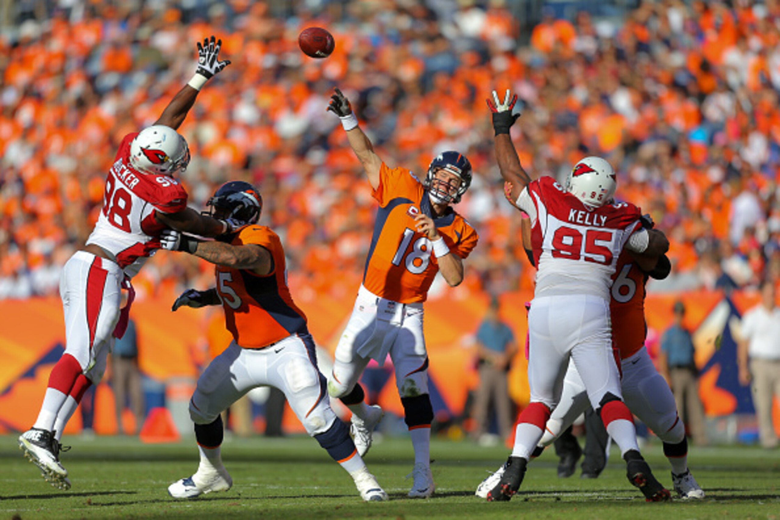 DENVER, CO - OCTOBER 5:  Quarterback Peyton Manning #18 of the Denver Broncos passes against the Arizona Cardinals during a game at Sports Authority Field at Mile High on October 5, 2014 in Denver, Colorado.  (Photo by Justin Edmonds/Getty Images)