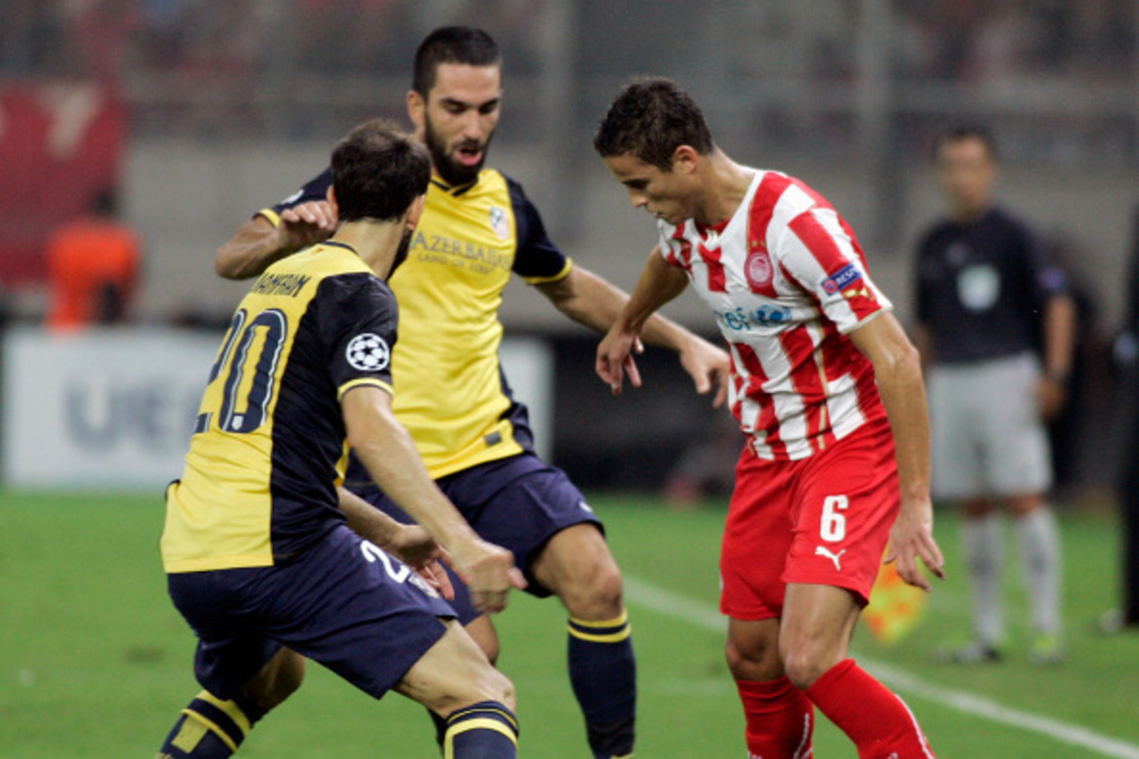 ATHENS, GREECE - SEPTEMBER 16:   Olympiacos Ibrahim Afellay, right, is challenged by Atletico's Juanfan during  the Champions League Group A soccer match between Olympiakos and Atletico Madrid at Georgios Karaiskakis Stadium in  Piraeus near Athens, Tuesd