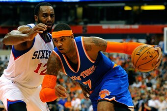 SYRACUSE, NY - OCTOBER 14:  Carmelo Anthony #7 of the New York Knicks drives to the basket past Luc Richard Mbah a Moute #12 of the Philadelphia 76ers during a preseason game at the Carrier Dome on October 14, 2014 in Syracuse, New York.  NOTE TO USER: Us