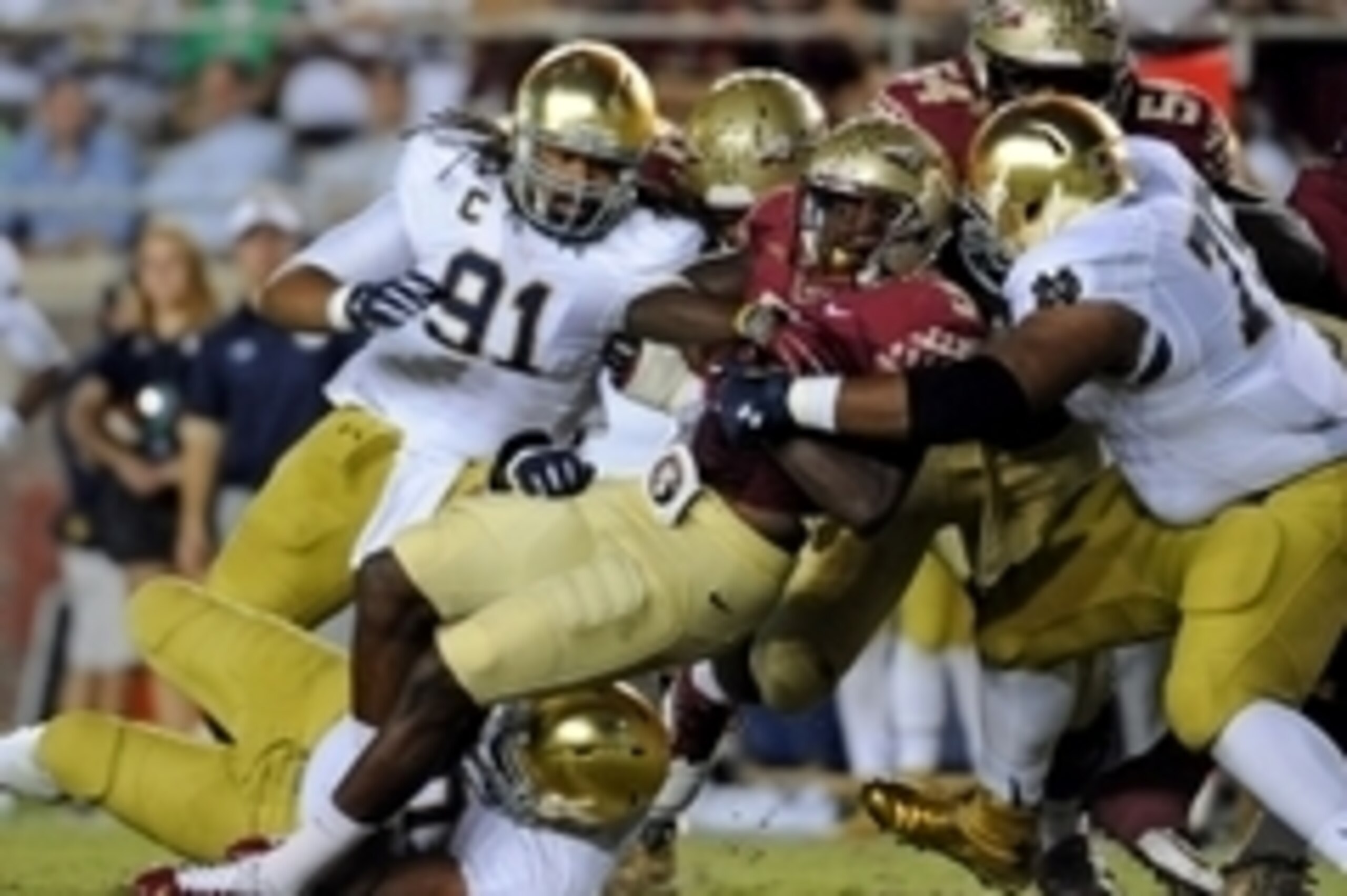 Oct 18, 2014; Tallahassee, FL, USA; Florida State Seminoles running back Karlos Williams (9) runs the ball and is tackled by Notre Dame Fighting Irish defensive lineman Daniel Cage (75) during the first half at Doak Campbell Stadium. Mandatory Credit: Mel
