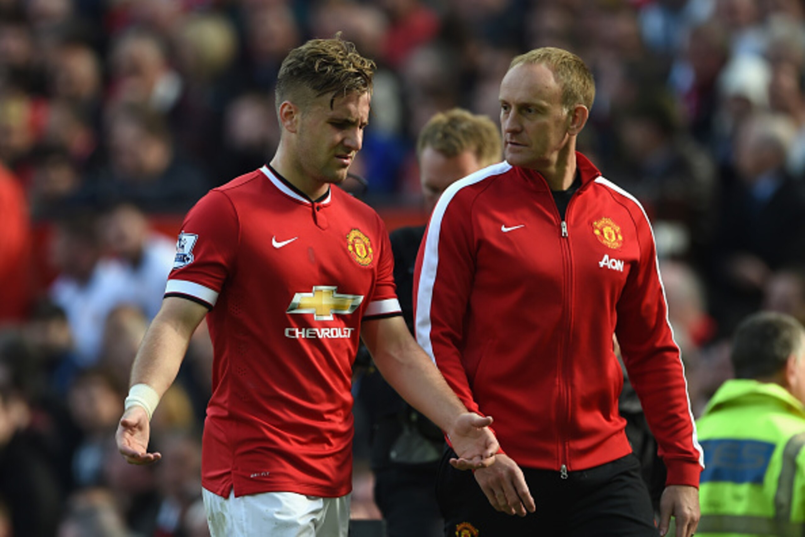 MANCHESTER, ENGLAND - OCTOBER 05:  Luke Shaw of Manchester United is helped off with an injury during the Barclays Premier League match between Manchester United and Everton at Old Trafford on October 5, 2014 in Manchester, England.  (Photo by Michael Reg