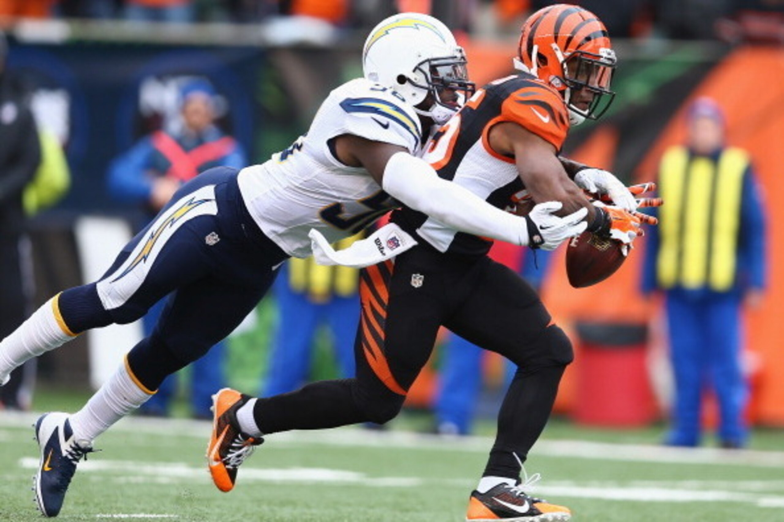 CINCINNATI, OH - JANUARY 05: Gio Bernard #25 of the Cincinnati Bengals carries the ball as outside linebacker Tourek Williams #58 of the San Diego Chargers defends  at Paul Brown Stadium on January 5, 2014 in Cincinnati, Ohio.  (Photo by Andy Lyons/Getty 