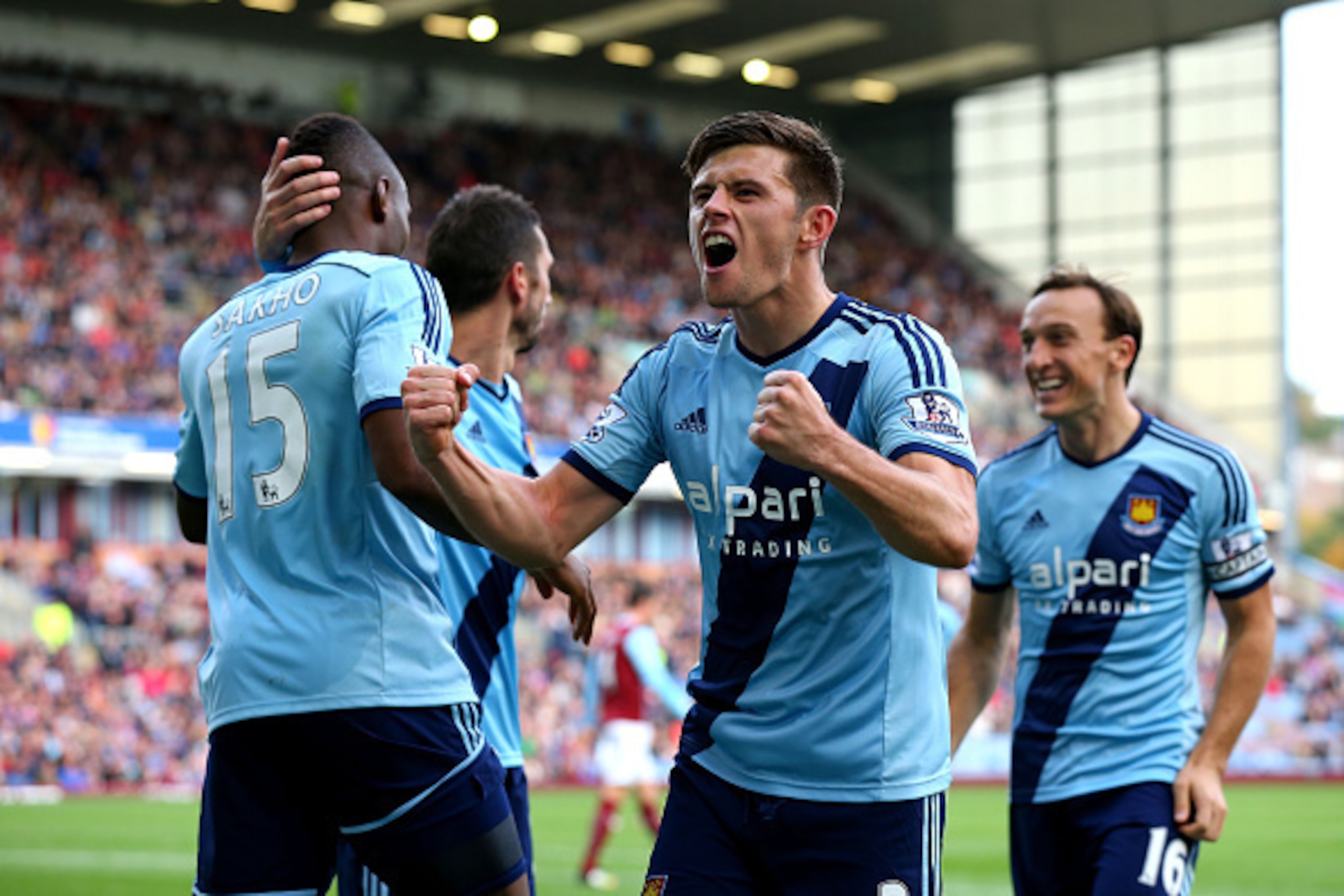 BURNLEY, ENGLAND - OCTOBER 18:  Aaron Cresswell of West Ham celerates after teammate Diafra Sakho #15 scores the opening goal during the Barclays Premier League match between Burnley and West Ham United at Turf Moor on October 18, 2014 in Burnley, England