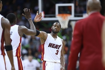 KANSAS CITY, MO - OCTOBER 17:  Dwyane Wade #3 of the Miami Heat high fives a temmate during a game against the Golden State Warriors on October 17, 2014 at Sprint Center in Kansas City, Missouri. NOTE TO USER:  User expressly acknowledges and agrees that,