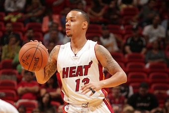 MIAMI, FL - October 7: Shabazz Napier #13 of the Miami Heat dribbles upcourt against the Orlando Magic at the American Airlines Arena in Miami, Florida on October 7, 2014. NOTE TO USER: User expressly acknowledges and agrees that, by downloading and/or us