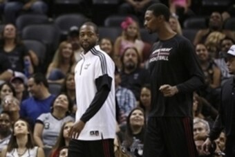 Oct 18, 2014; San Antonio, TX, USA; Miami Heat shooting guard Dwyane Wade (3) and power forward Chris Bosh (1) walk onto the court during the second half against the San Antonio Spurs at AT&T Center. The Heat won 111-108 in overtime. Mandatory Credit: Soo