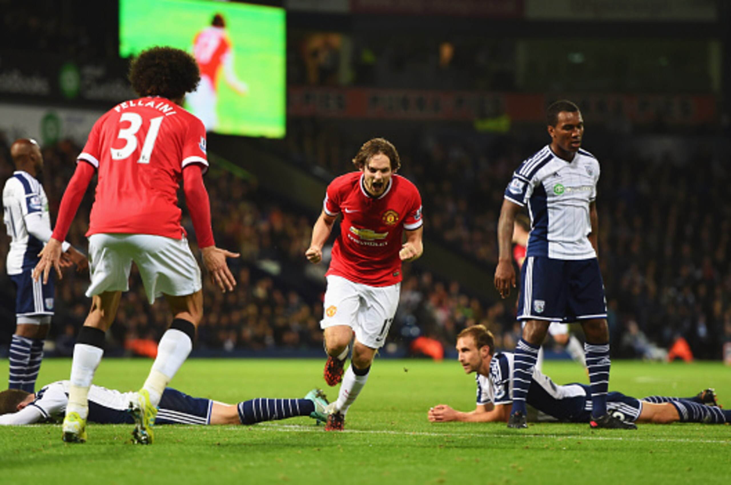 WEST BROMWICH, ENGLAND - OCTOBER 20:  West Bromwich Albion defenders look dejected as Daley Blind of Manchester United (17) celebrates scoring their second and equalising goal with Marouane Fellaini during the Barclays Premier League match between West Br
