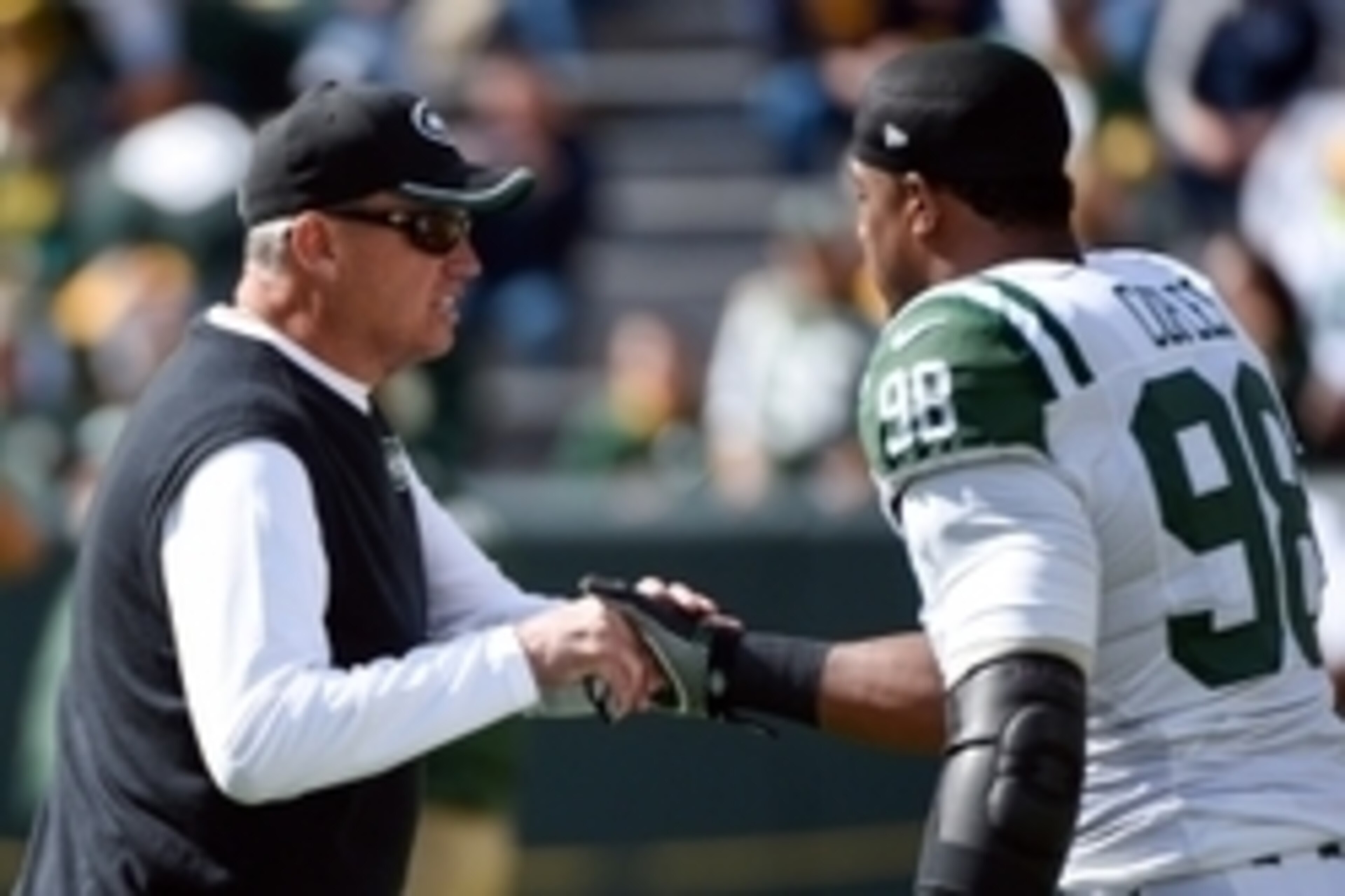 Sep 14, 2014; Green Bay, WI, USA;  New York Jets head coach Rex Ryan greets New York Jets linebacker Quinton Coples (98) before game against the Green Bay Packers at Lambeau Field. Mandatory Credit: Benny Sieu-USA TODAY Sports