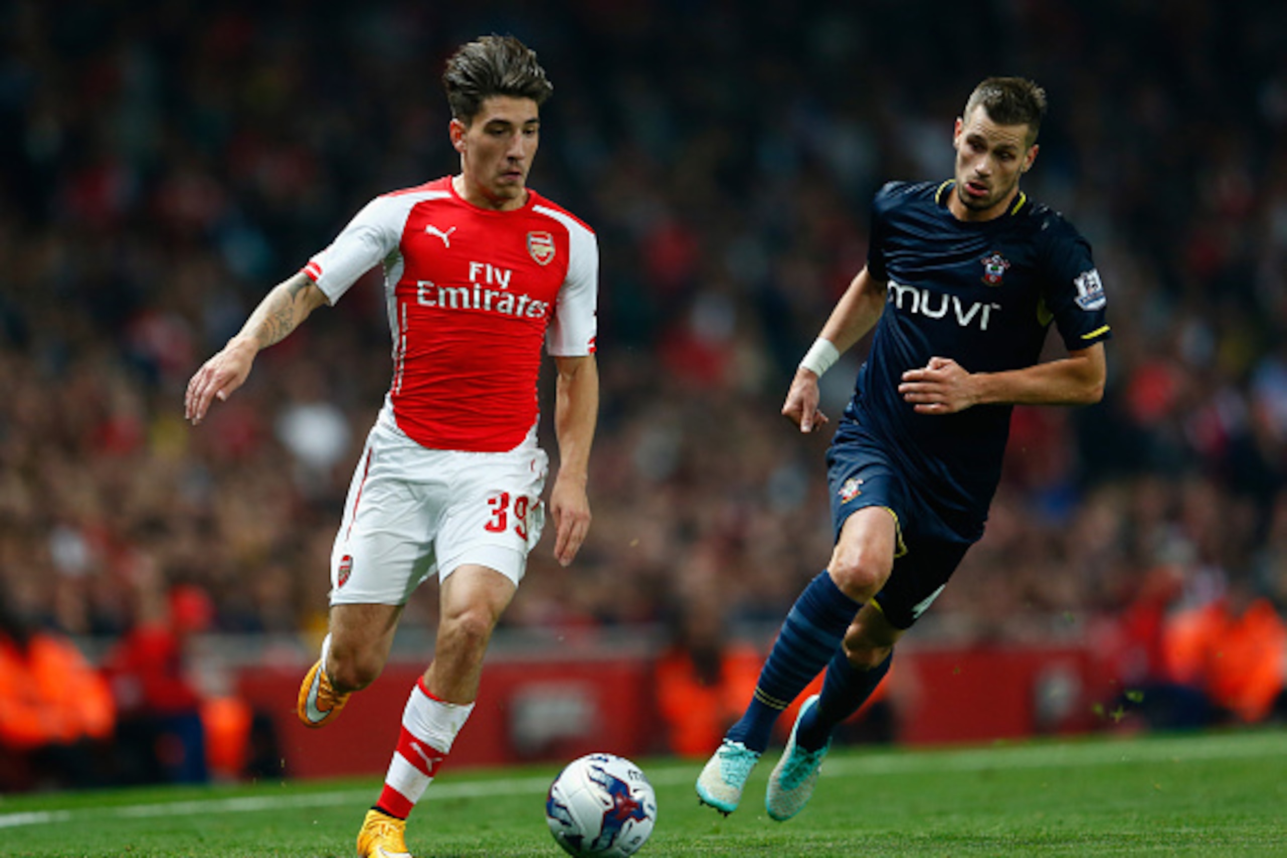 LONDON, ENGLAND - SEPTEMBER 23:  Hector Bellerin of Arsenal moves away from Morgan Schneiderlin of Southampton during the Capital One Cup Third Round match between Arsenal and Southampton at the Emirates Stadium on September 23, 2014 in London, England.  