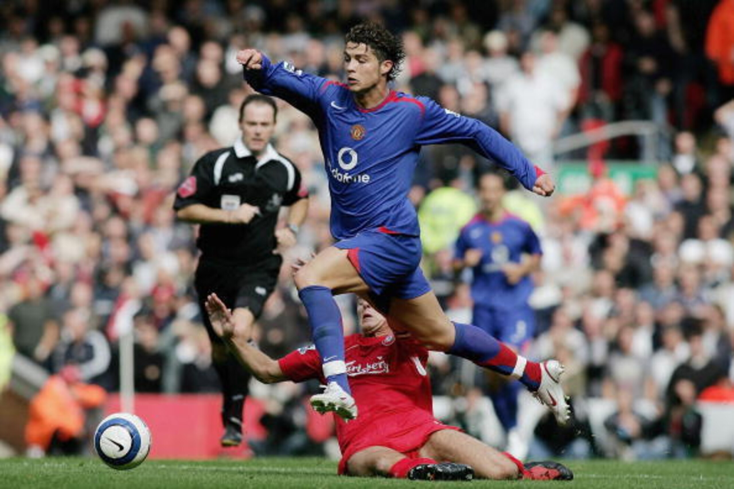 LIVERPOOL, UNITED KINGDOM - SEPTEMBER 18:  Steven Gerrard of Liverpool tackles but misses Cristiano Ronaldo of Manchester United during the Barclays Premiership match between Liverpool and Manchester United at Anfield on September 18, 2005 in Liverpool, E