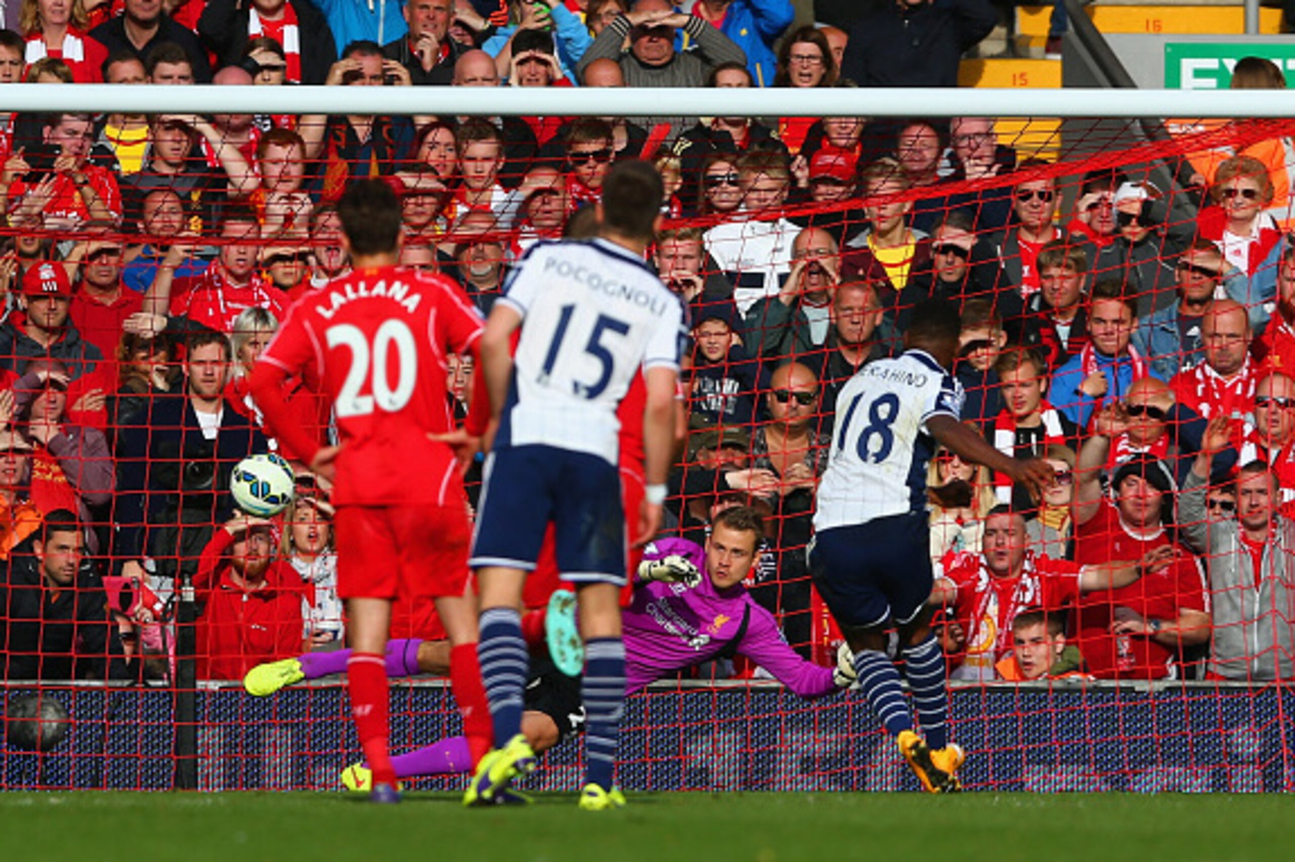 LIVERPOOL, ENGLAND - OCTOBER 04:  Saido Berahino of West Brom scores from the penalty spot past Simon Mignolet of Liverpool during the Barclays Premier League match between Liverpool and West Bromwich Albion at Anfield on October 4, 2014 in Liverpool, Eng