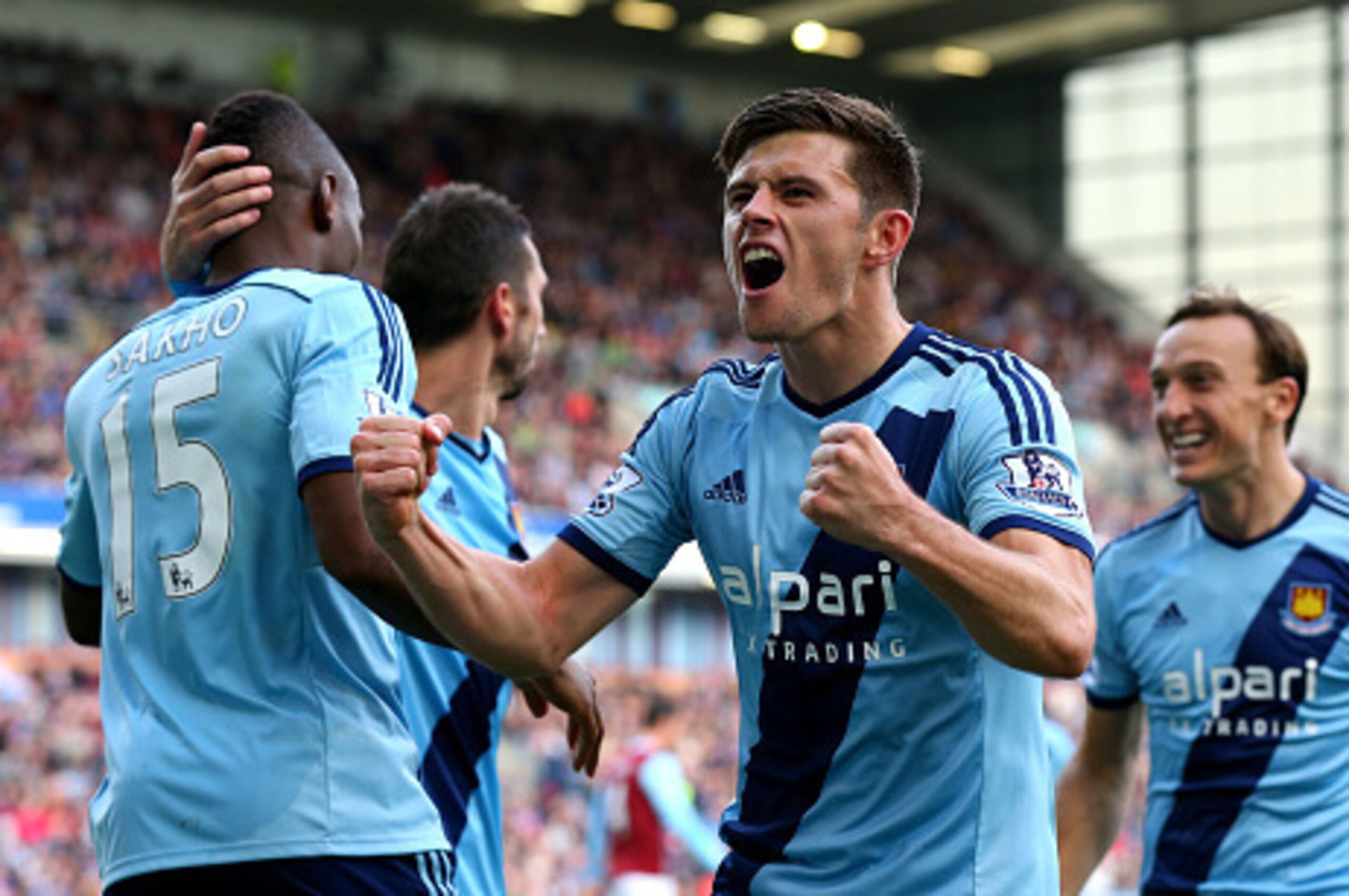 BURNLEY, ENGLAND - OCTOBER 18:  Aaron Cresswell of West Ham celerates after teammate Diafra Sakho #15 scores the opening goal during the Barclays Premier League match between Burnley and West Ham United at Turf Moor on October 18, 2014 in Burnley, England
