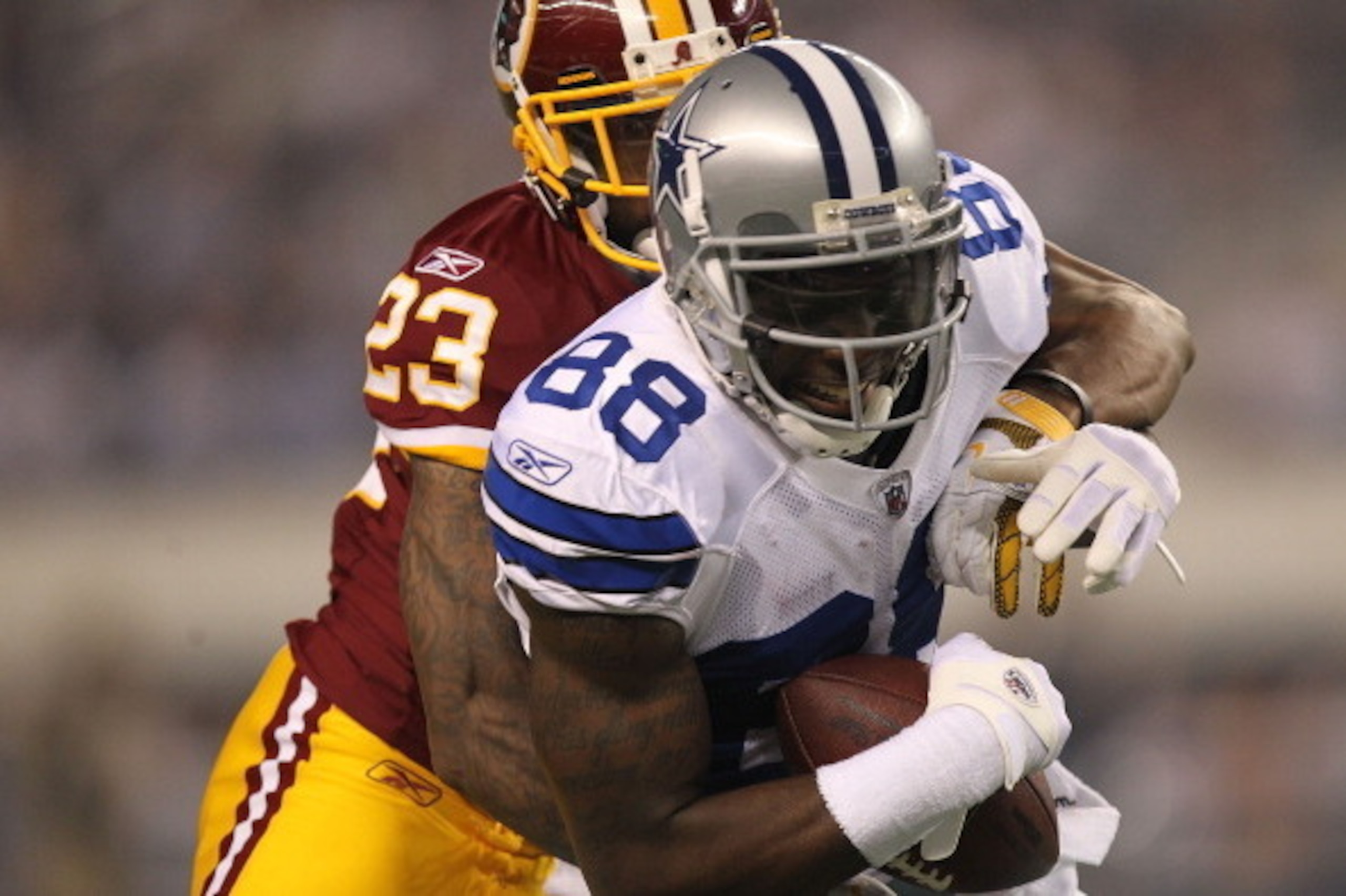 ARLINGTON, TX - SEPTEMBER 26:   Dez Bryant #88 of the Dallas Cowboys makes a pass reception against  DeAngelo Hall #23 of the Washington Redskins at Cowboys Stadium on September 26, 2011 in Arlington, Texas.  (Photo by Ronald Martinez/Getty Images)