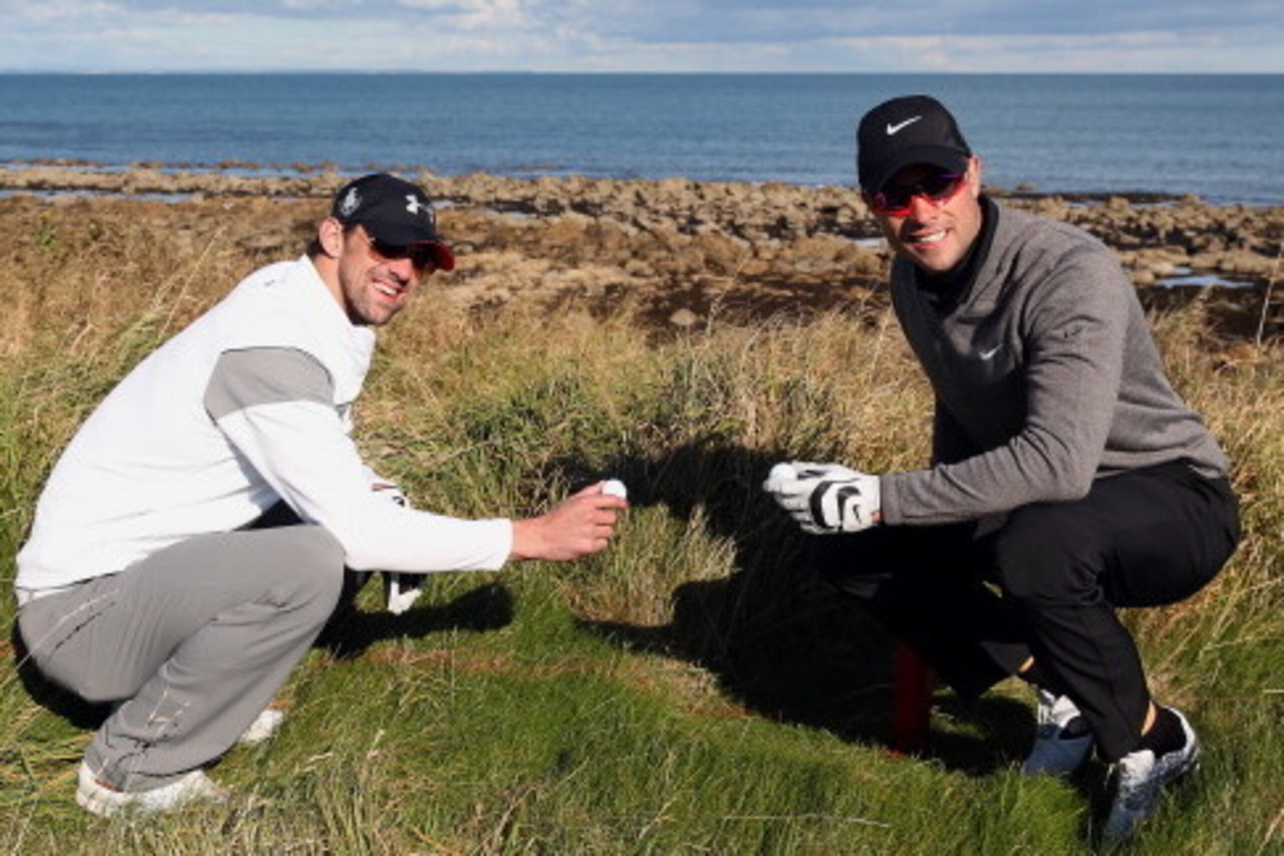 KINGSBARNS, SCOTLAND - OCTOBER 05:  Oscar Pistorius and Michael Phelps pose for a picture after they both lose their ball on the third hole during the second round of The Alfred Dunhill Links Championship at Kingsbarns Golf Links on October 5, 2012 in Kin